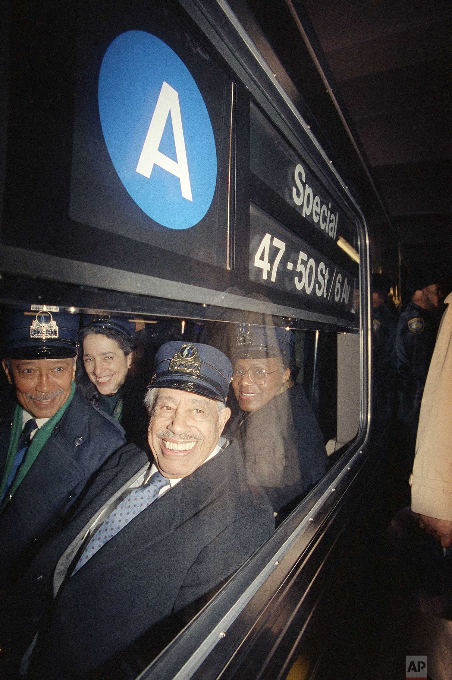  Mayor David Dinkins, left, and entertainer Cab Calloway, right, take a ride on the A train from Harlem to Radio City Music Hall to officially kick off Grammy Week in New York on Feb. 18, 1991. Seated behind is Manhattan borough president Ruth Messin