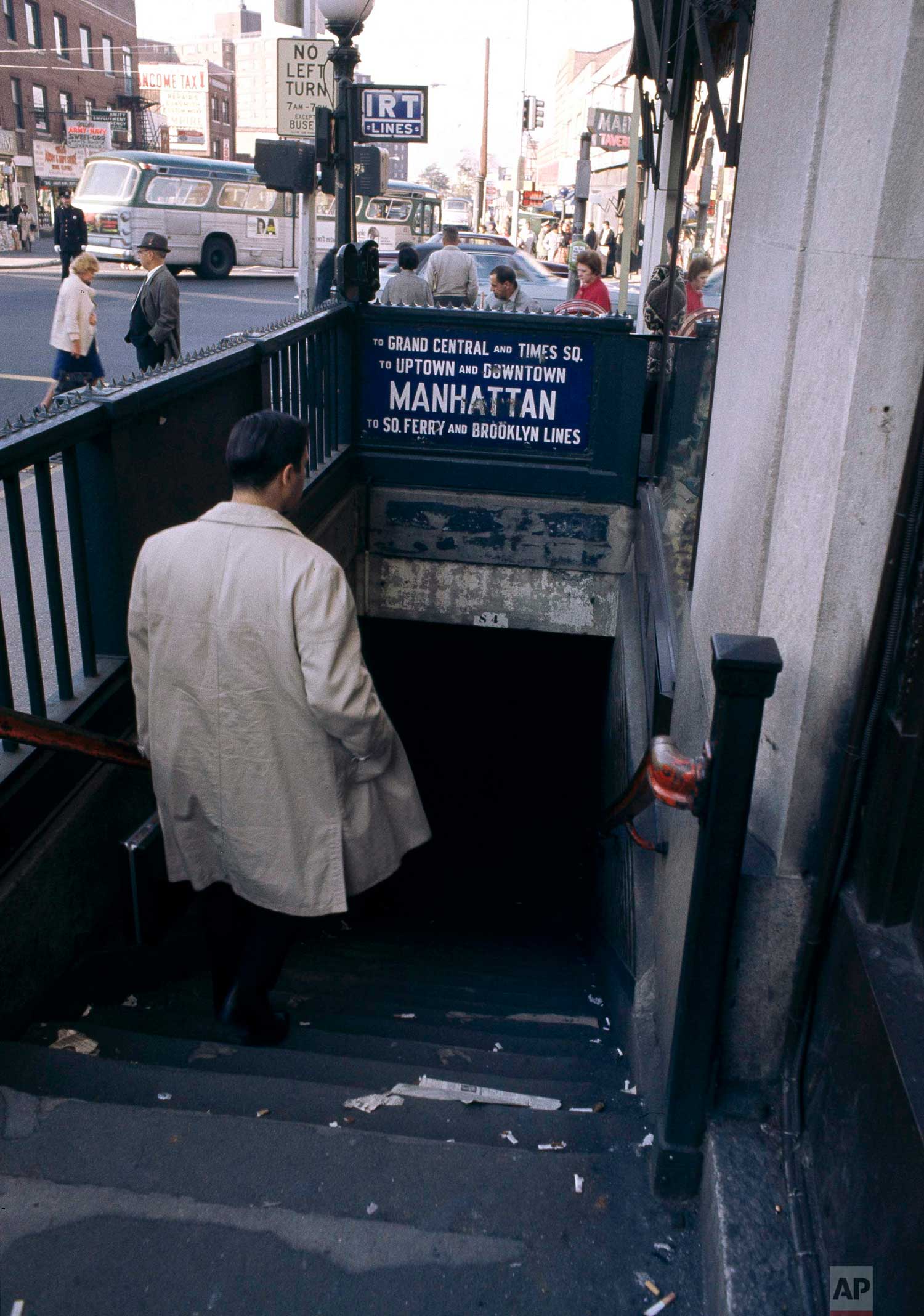  A man heads underground for a ride on the subway, in New York City, 1966. (AP Photo) 