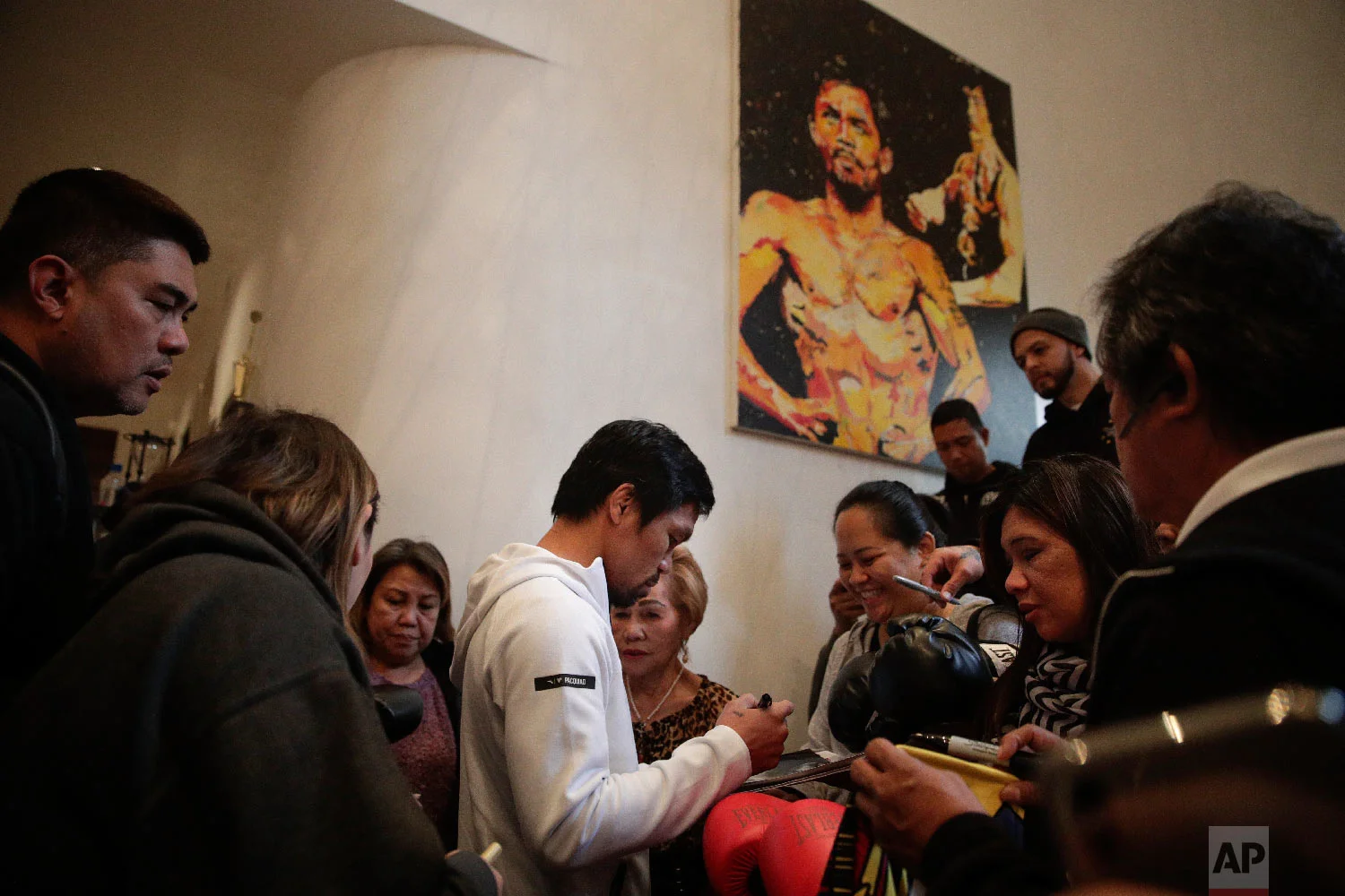 Boxer Manny Pacquiao is surrounded by guests at his home Jan. 14, 2019, in Los Angeles. (AP Photo/Jae C. Hong)
