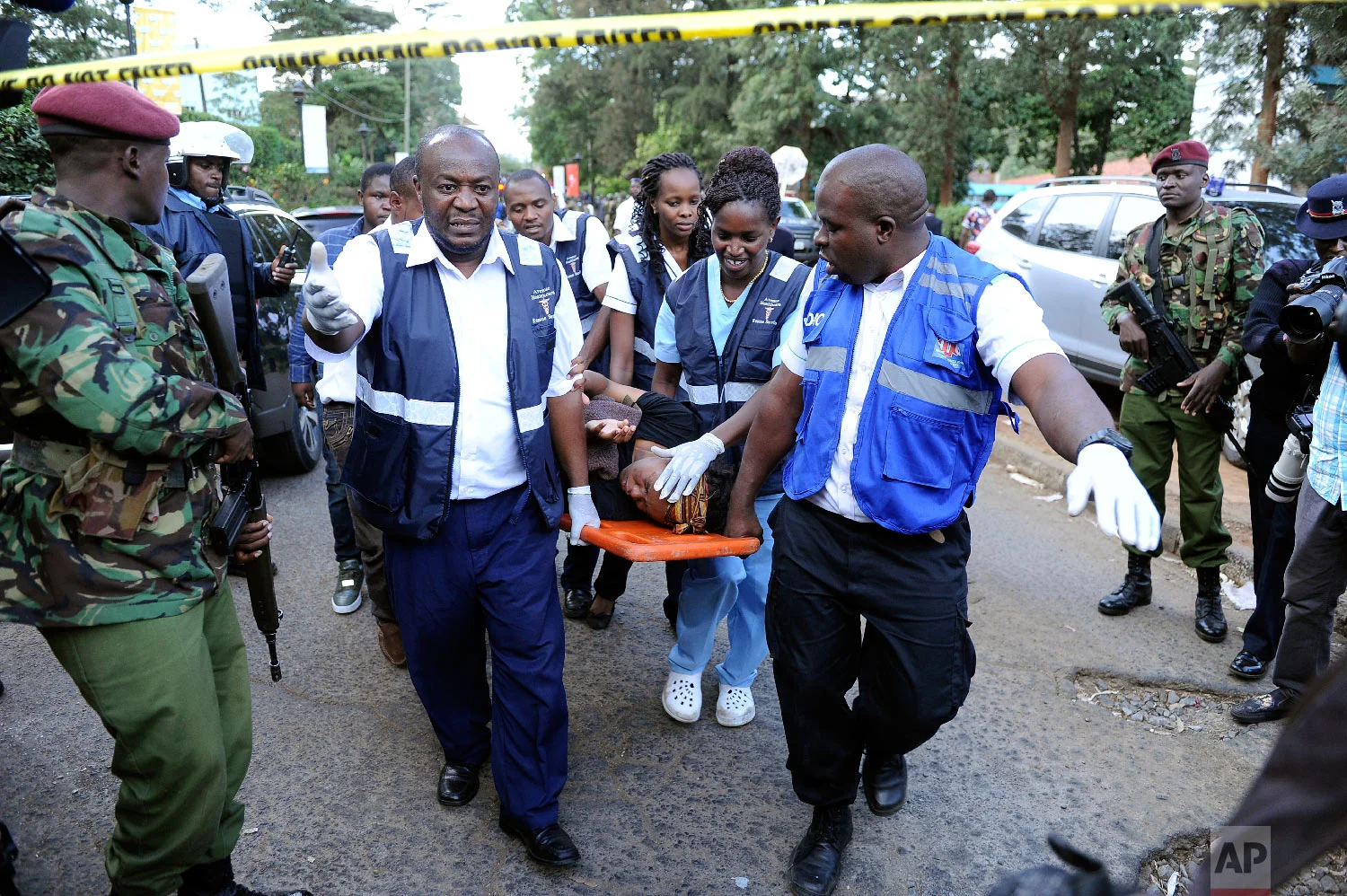 Medics rescue a civilian from the scene at a hotel complex in Nairobi, Kenya Tuesday, Jan. 15, 2019. (AP Photo/John Muchucha)