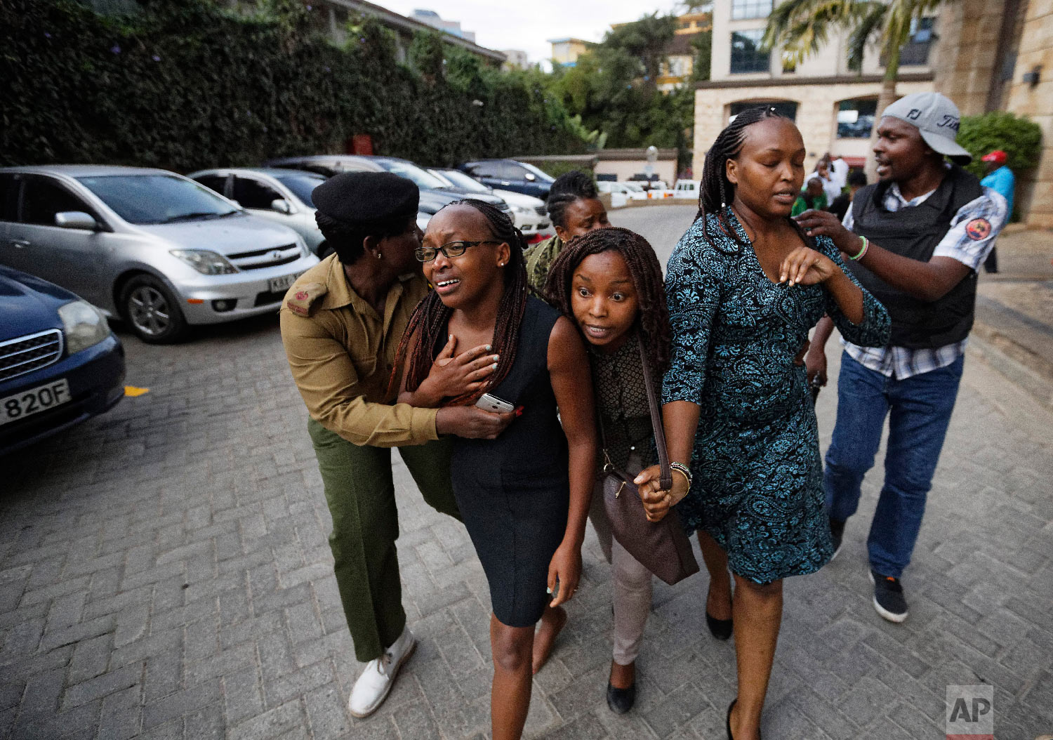 Civilians flee the scene at a hotel complex in Nairobi, Kenya, Jan. 