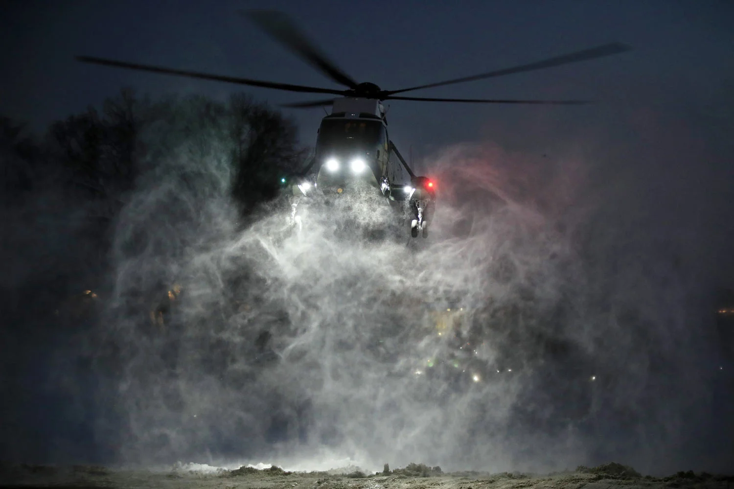 Propellers of the Marine One helicopter carrying President Donald Trump kick up snow as it lands on the South Lawn of the White House, in Washington, Monday, Jan. 14, 2019. Trump returned to the White House from a trip to New Orleans. (AP Photo/Manuel Balce Ceneta)