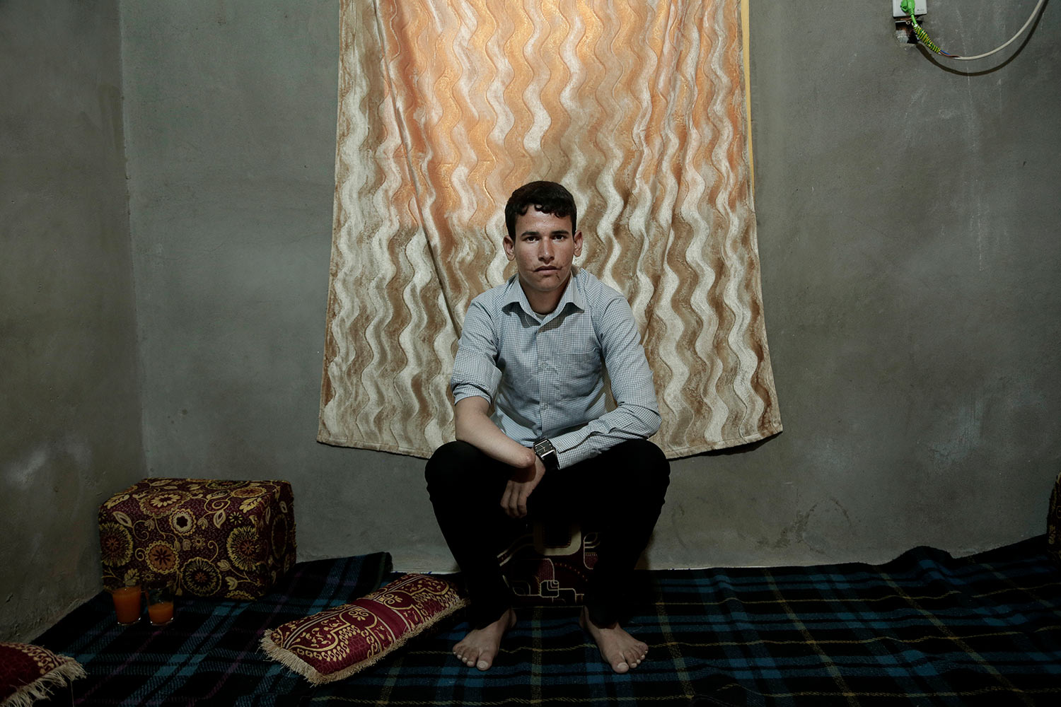  In this July 26, 2018 photo, 16 year-old Osama Faed Ashal, a land mine victim, poses for a photograph in his home in Marib, Yemen, (AP Photo/Nariman El-Mofty) 