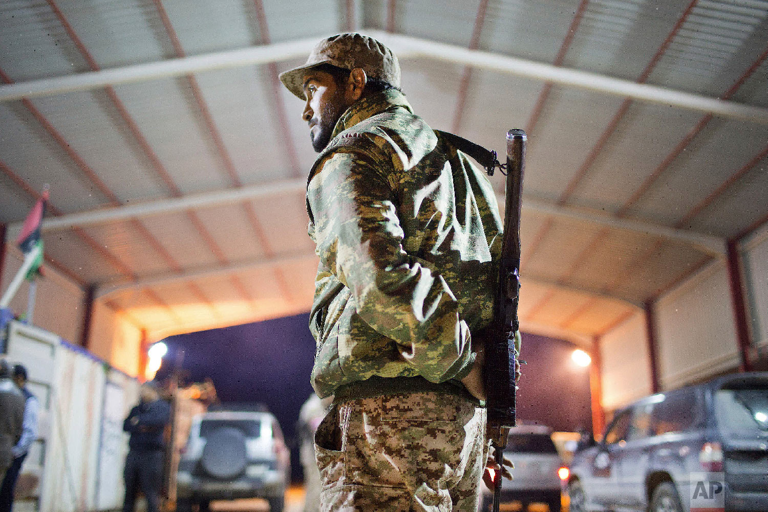  A Libyan military soldier stands guard at the entrance of a town, 110 kilometers (68 miles) from Sirte, Libya, Wednesday, Feb. 18, 2015. (AP Photo/Mohamed Ben Khalifa) 