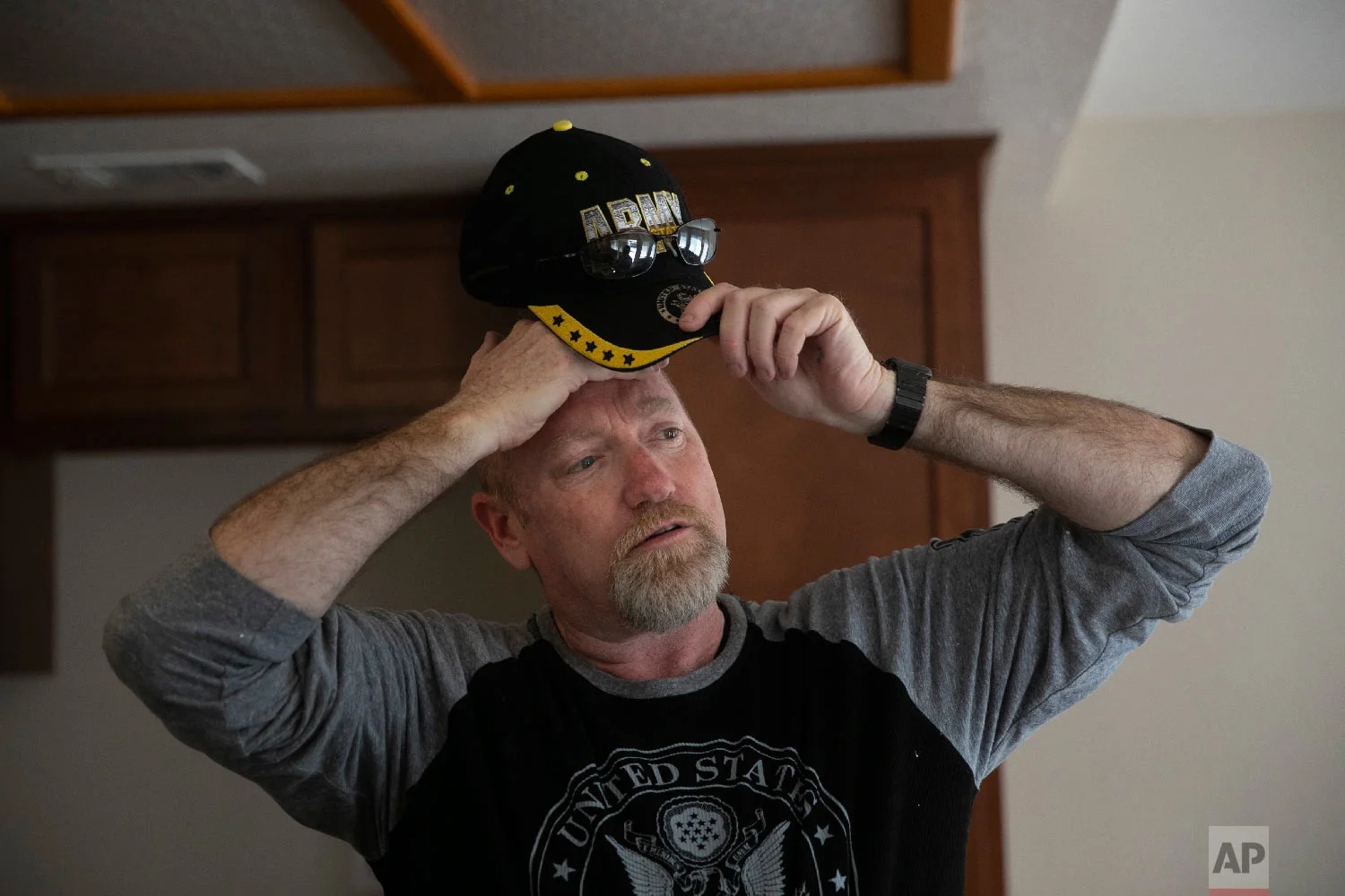 Chris George, a federal employee furloughed from his job as a forestry technician supervisor for the U.S. Department of Agriculture Forest Service, takes a short break while working as a handyman to make ends meet Saturday, Jan. 19, 2019, in Fontana, Calif. (AP Photo/Jae C. Hong)