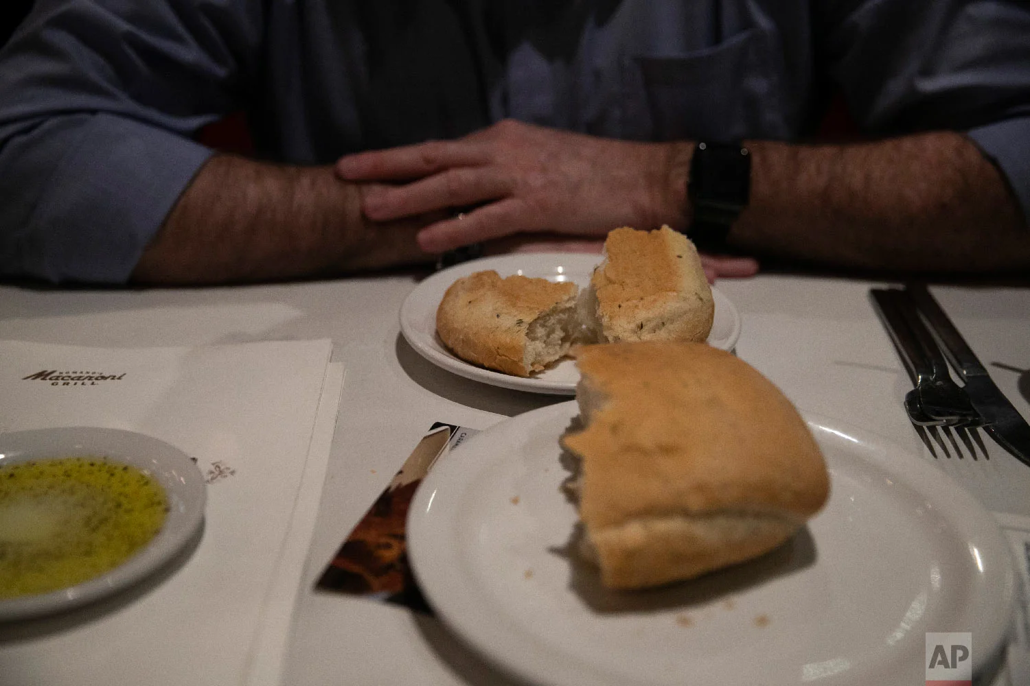 Chris George, a federal employee furloughed from his job as a forestry technician supervisor for the U.S. Department of Agriculture Forest Service, waits for his meal at a Romano's Macaroni Grill restaurant Saturday, Jan. 19, 2019, in Redlands, Calif. (AP Photo/Jae C. Hong)