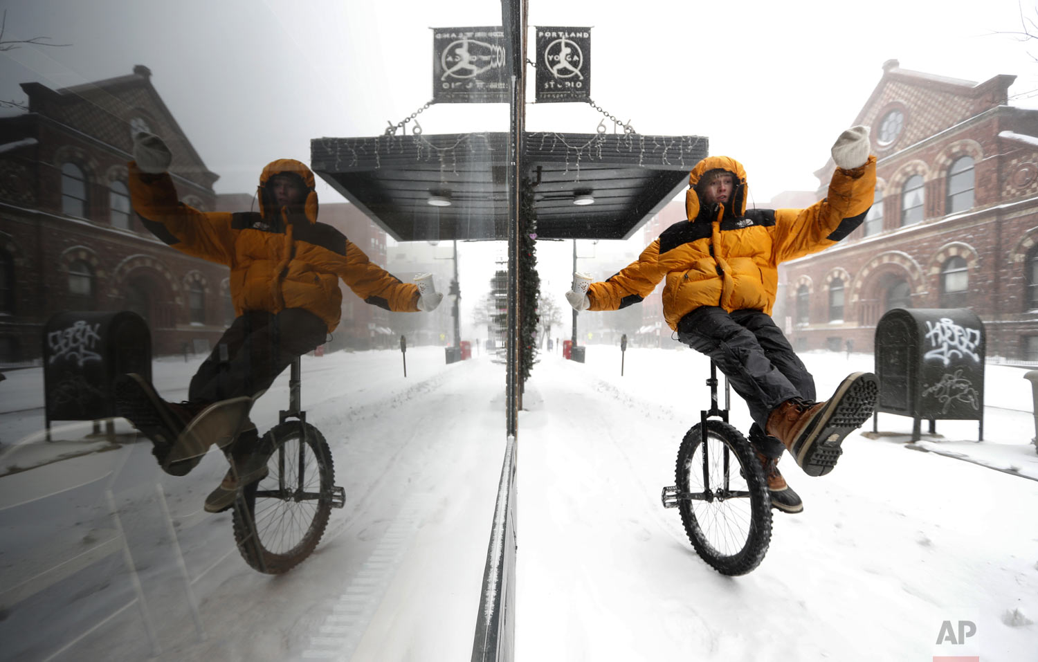 Caleb Seely rides a unicycle on a snow-covered sidewalk as he heads home after helping shovel out his brother's driveway during a winter storm, Sunday, Jan. 20, 2019, in Portland, Maine. The extra knobby tire on Seely's ride provided traction on a day when snow, sleet and freezing rain kept most motorists indoors. (AP Photo/Robert F. Bukaty)