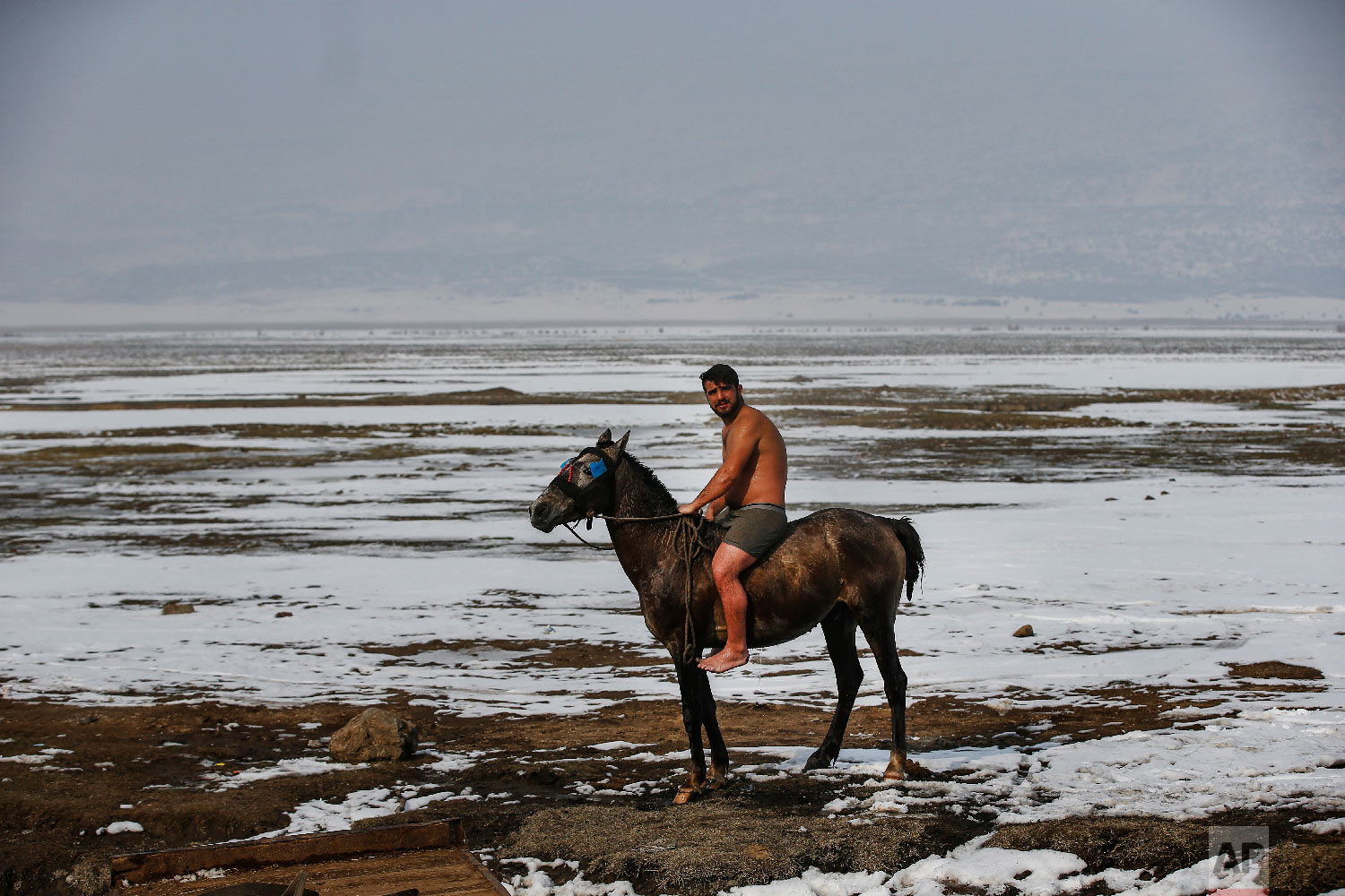  Muhammed Toren rides his horse after a bath in a hot spring along with his water buffaloes near the village of Budakli, in the mountainous Bitlis province of eastern Turkey, Thursday, Jan. 24, 2019. (AP Photo/Emrah Gurel) 