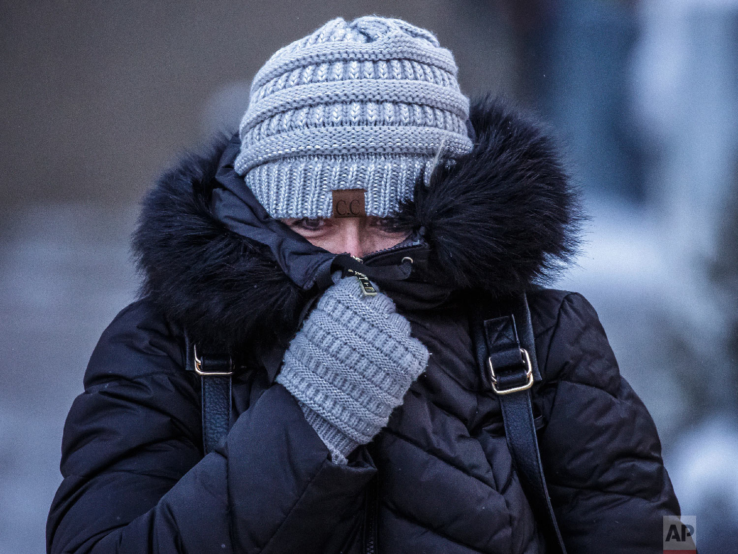  Andrea Billings keeps her face covered while walking across Center Street at its intersection with 1st Avenue in subzero temperatures on the way to her car after work Tuesday, Jan. 29, 2019, in downtown Rochester, Minn.  (Joe Ahlquist/The Rochester 