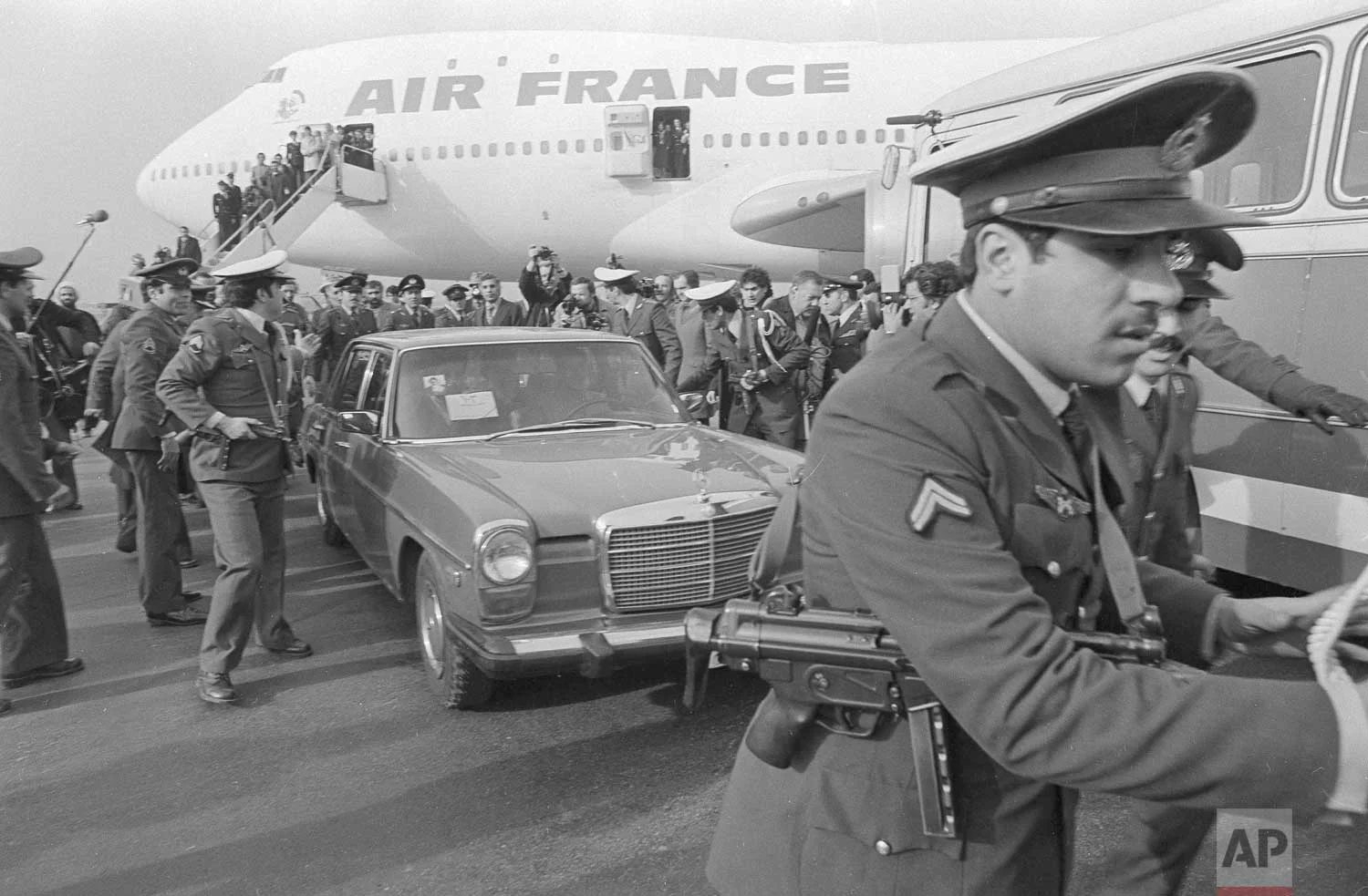 In this Feb. 1, 1979 photo, Ayatollah Ruhollah Khomeini has a heavy escort as he enters car to leave the airport in Tehran, Iran.(AP Photo)