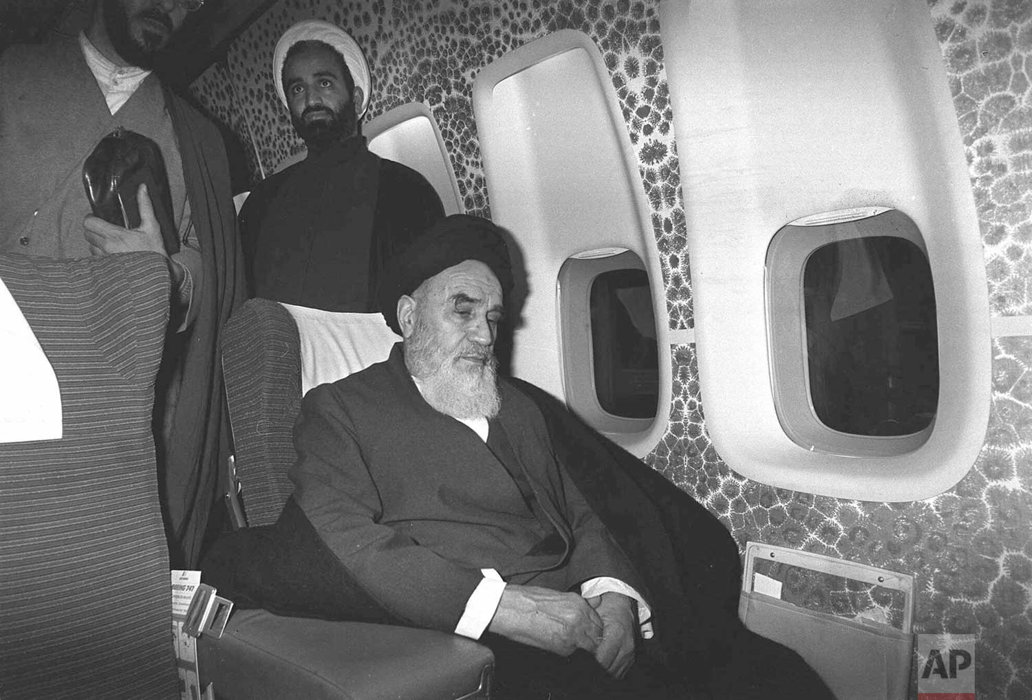  In this Feb. 1, 1979 photograph, Ayatollah Ruhollah Khomeini sits inside the chartered airplane which will fly him back to Iran, a few minutes before the plane took off from Paris, France. (AP Photo/Campion) 