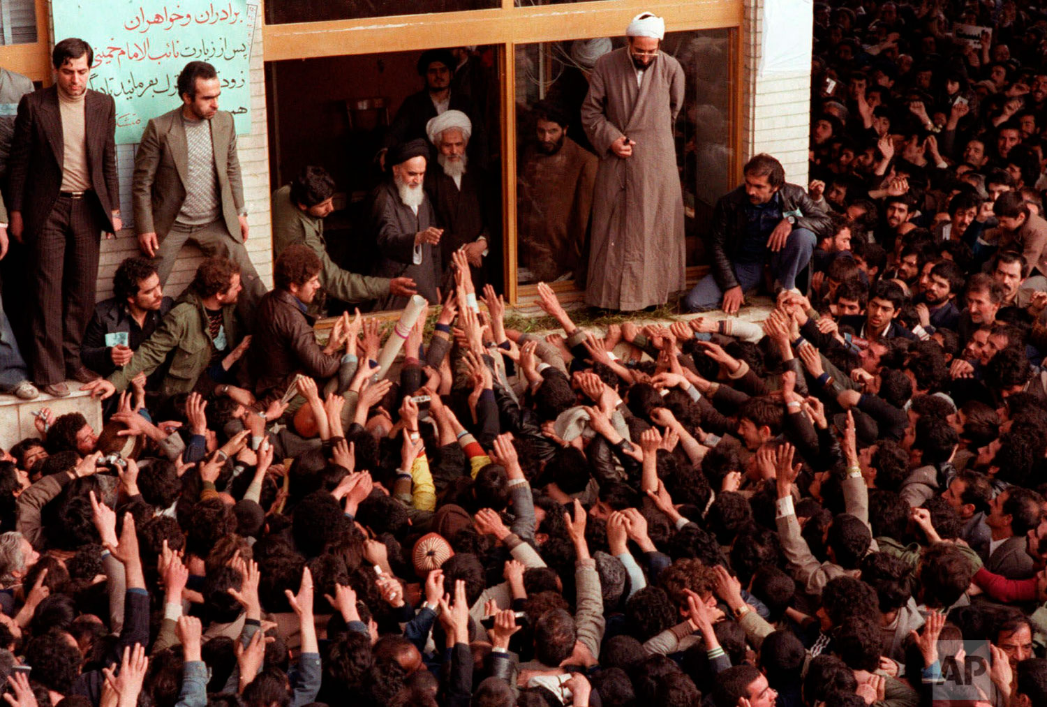  In this Feb. 2, 1979 photo, Ayatollah Ruhollah Khomeini, center, is greeted by supporters in Tehran, Iran. (AP Photo) 