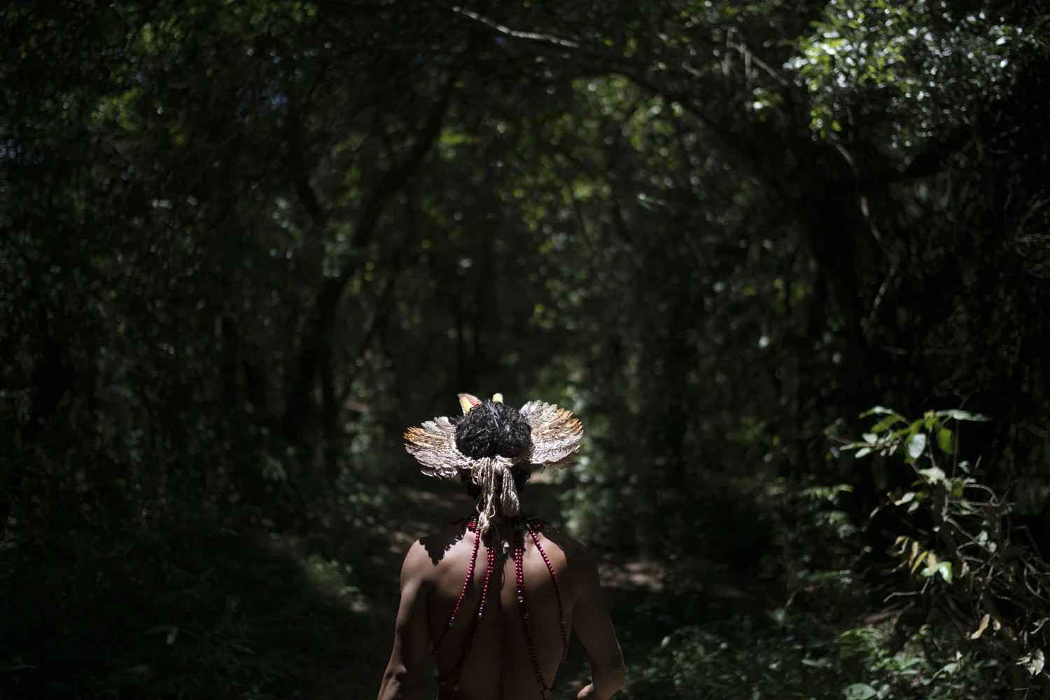 Hayo, chief of the Pataxo Ha-ha-hae indigenous community, walks toward the Paraopeba River days after the collapse of a mining company dam, near his village in Brumadinho, Brazil, Tuesday, Jan. 29, 2019. Vale company representatives insisted that th