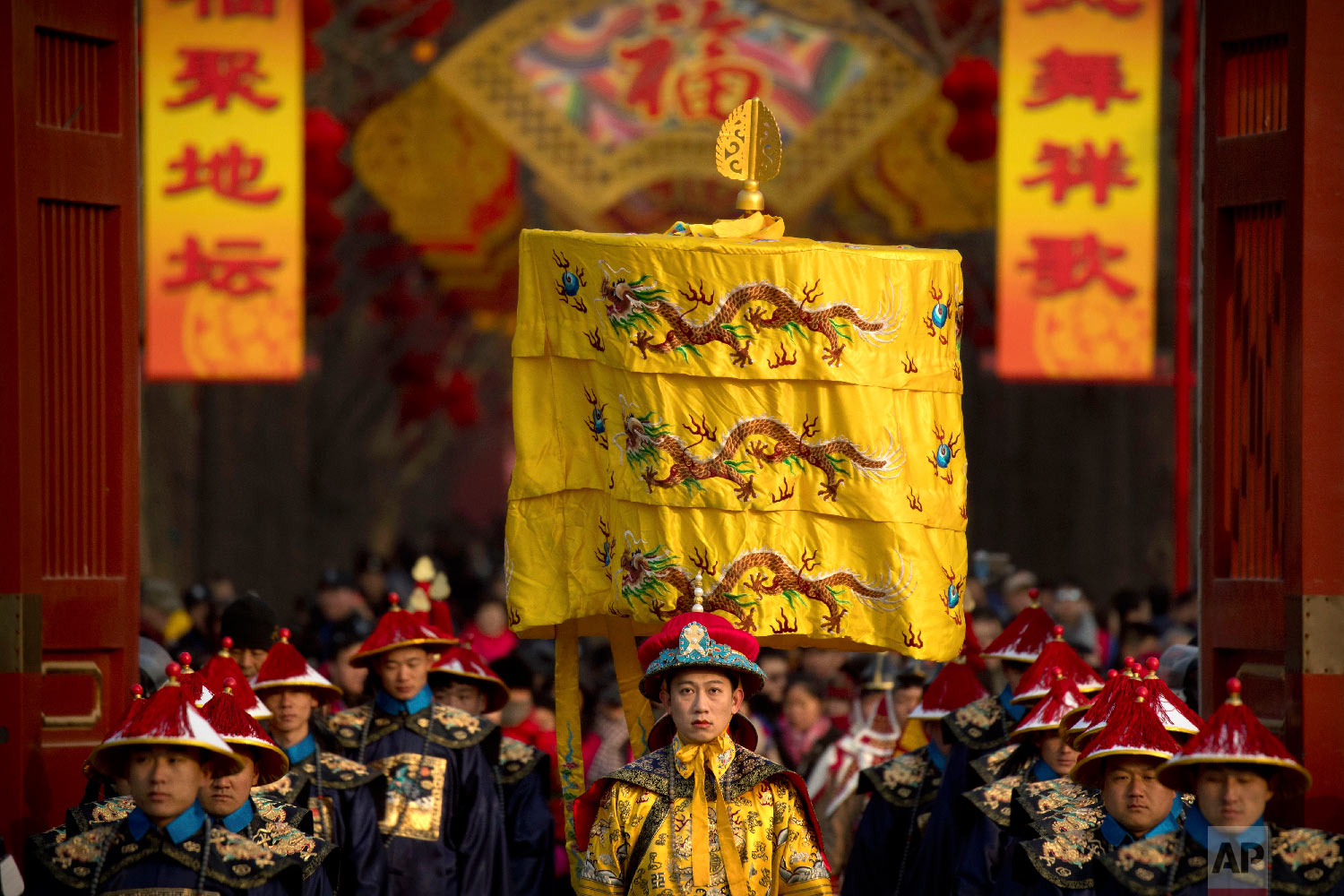  A performer dressed as an emperor, center, participates in a Qing Dynasty ceremony in which emperors prayed for good harvest and fortune at a temple fair in Ditan Park in Beijing, Tuesday, Feb. 5, 2019.  (AP Photo/Mark Schiefelbein) 