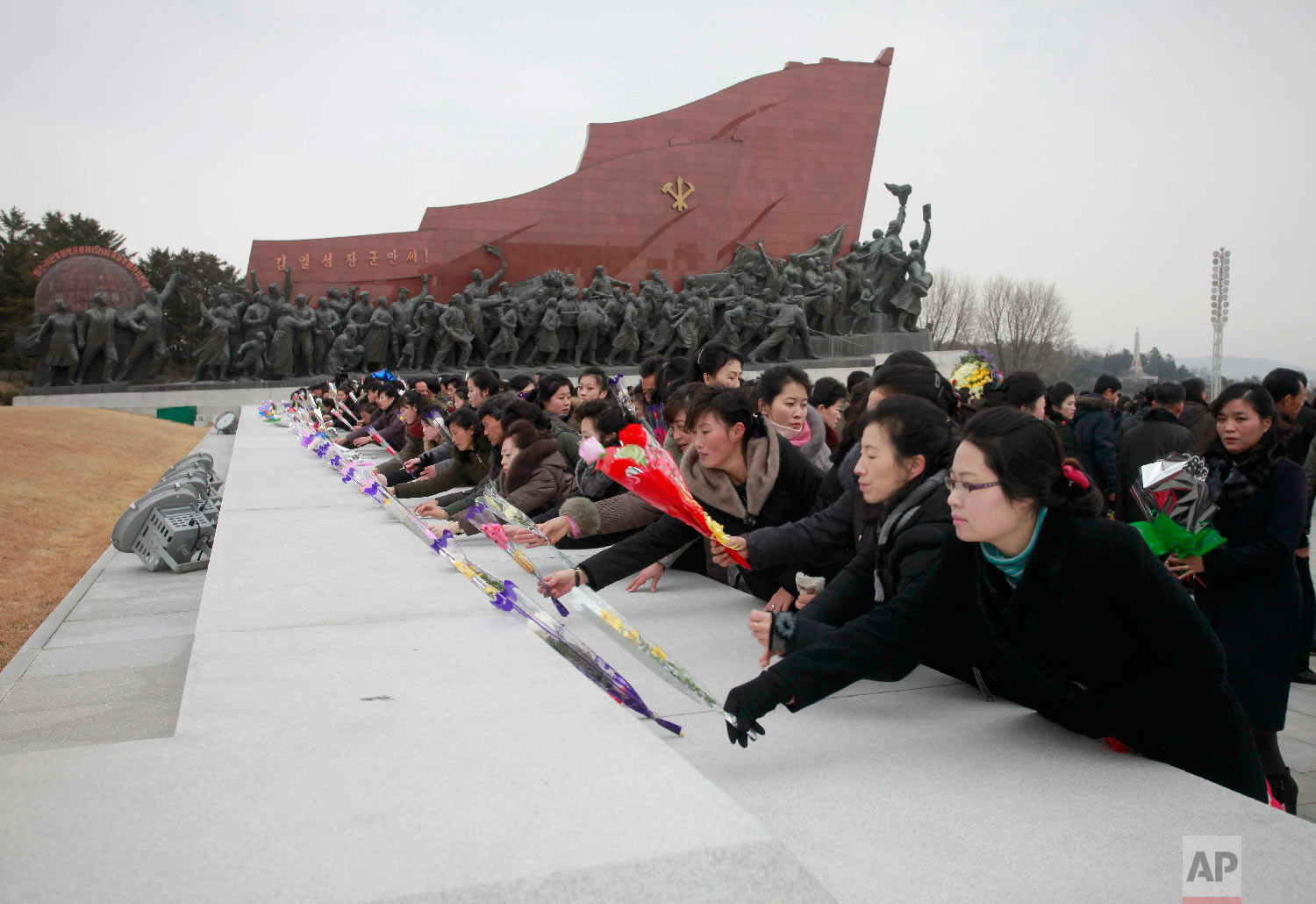  People visit statues of North Korean late leaders, Kim Il Sung and his son Kim Jong Il, to lay bouquets of flowers on the Lunar New Year in Pyongyang, North Korea, Tuesday, Feb. 5, 2019. (AP Photo/Jon Chol Jin) 