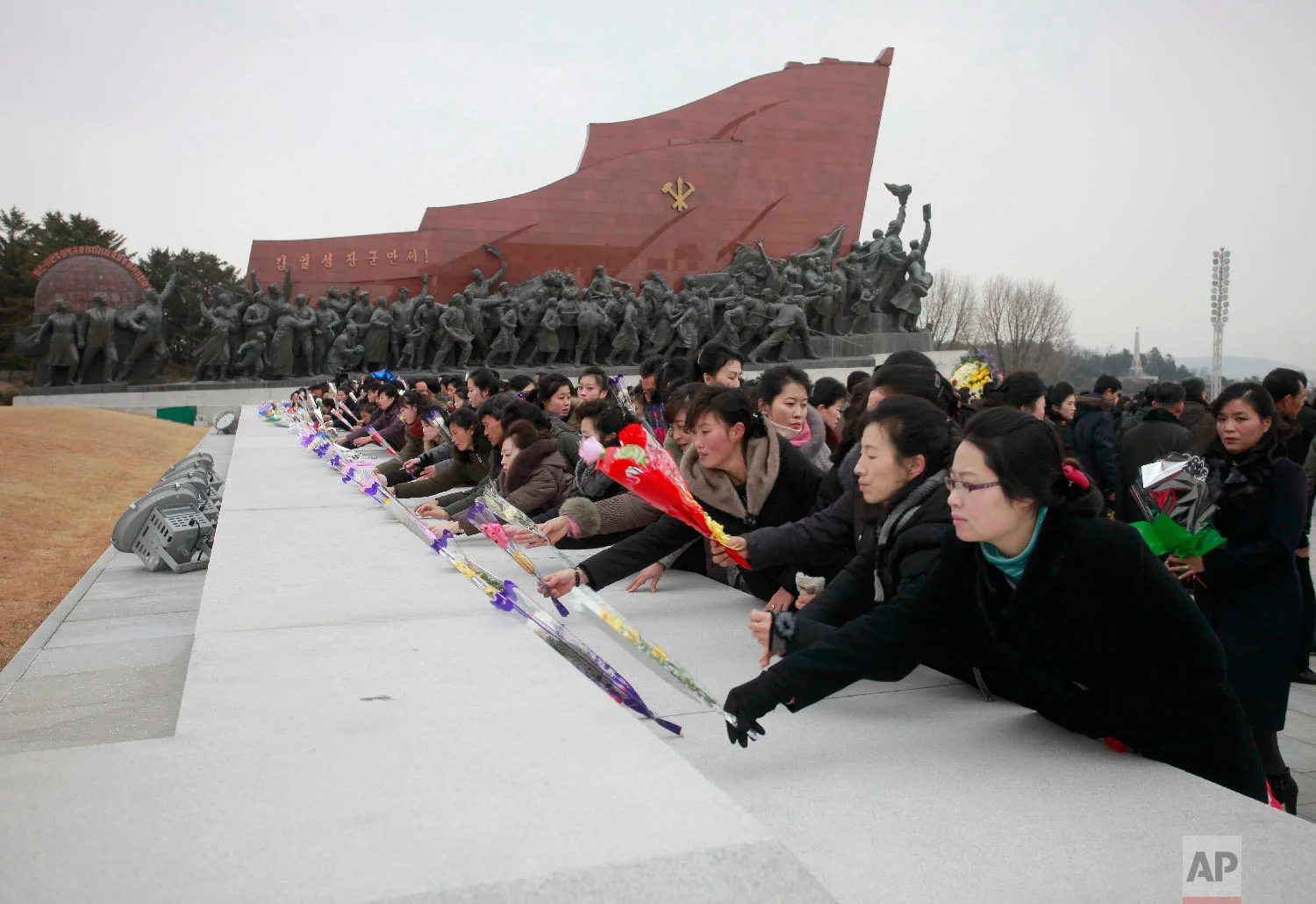 People visit statues of North Korean late leaders, Kim Il Sung and his son Kim Jong Il, to lay bouquets of flowers on the Lunar New Year in Pyongyang, North Korea, Tuesday, Feb. 5, 2019. (AP Photo/Jon Chol Jin)