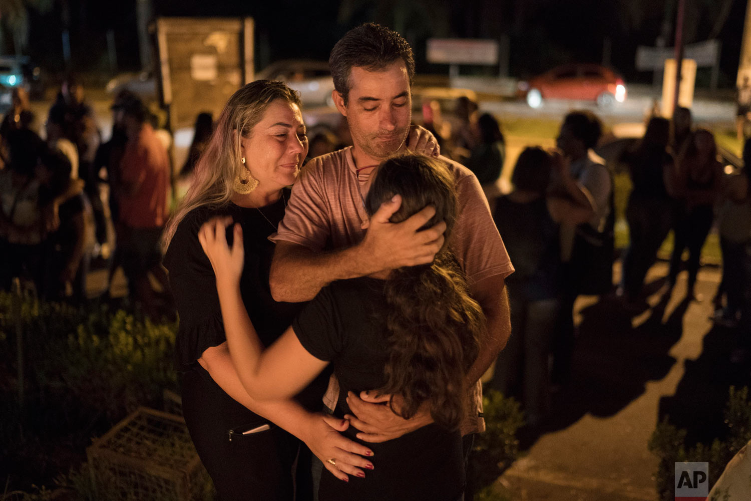  A family embraces during a vigil for the victims of the collapsed mining dam in Brumadinho, Brazil, Jan. 29, 2019. (AP Photo/Leo Correa) 