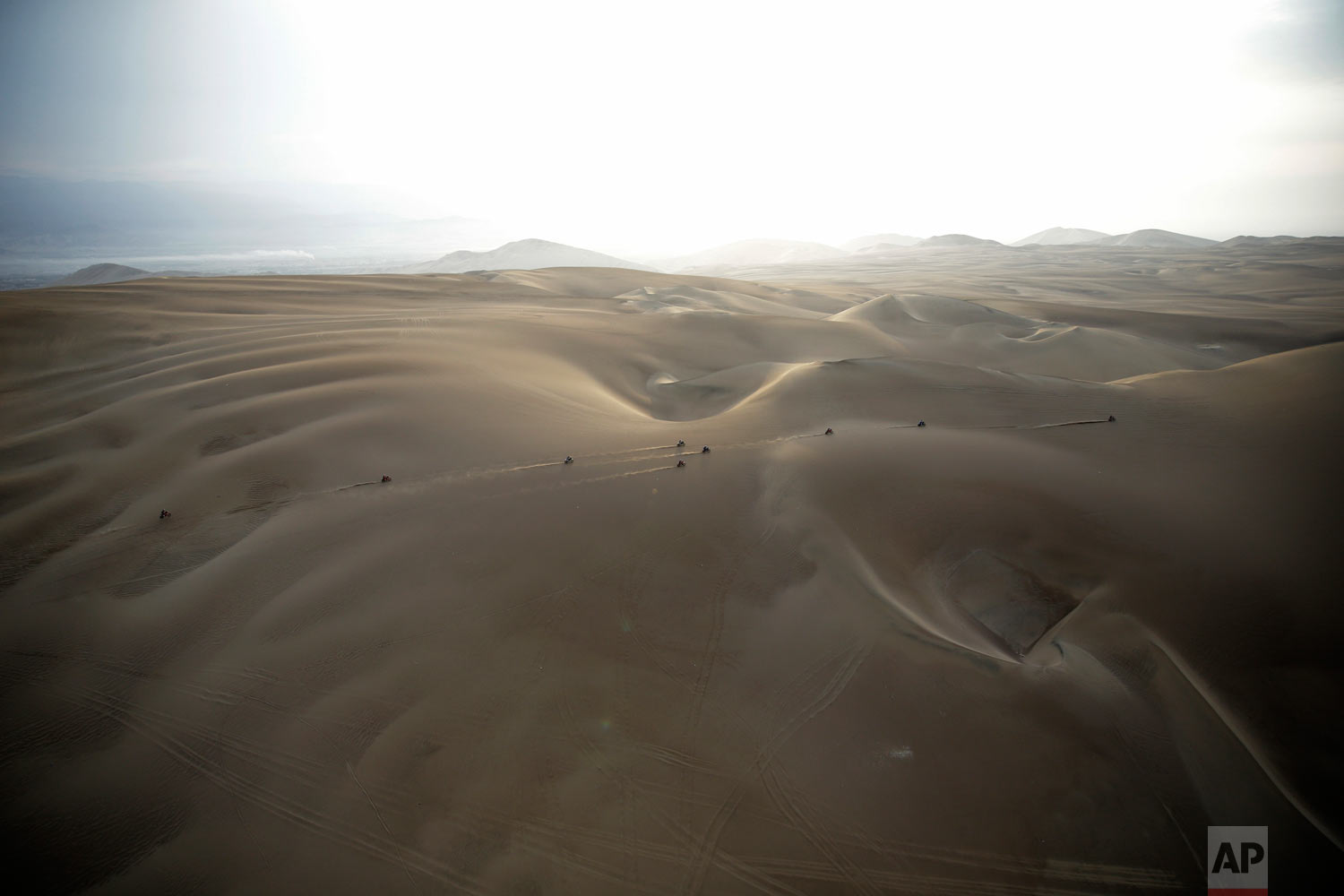  Competitors ride their motorbikes across the dunes during stage nine of the Dakar Rally in Pisco, Peru, Jan. 16, 2019. (AP Photo/Ricardo Mazalan) 