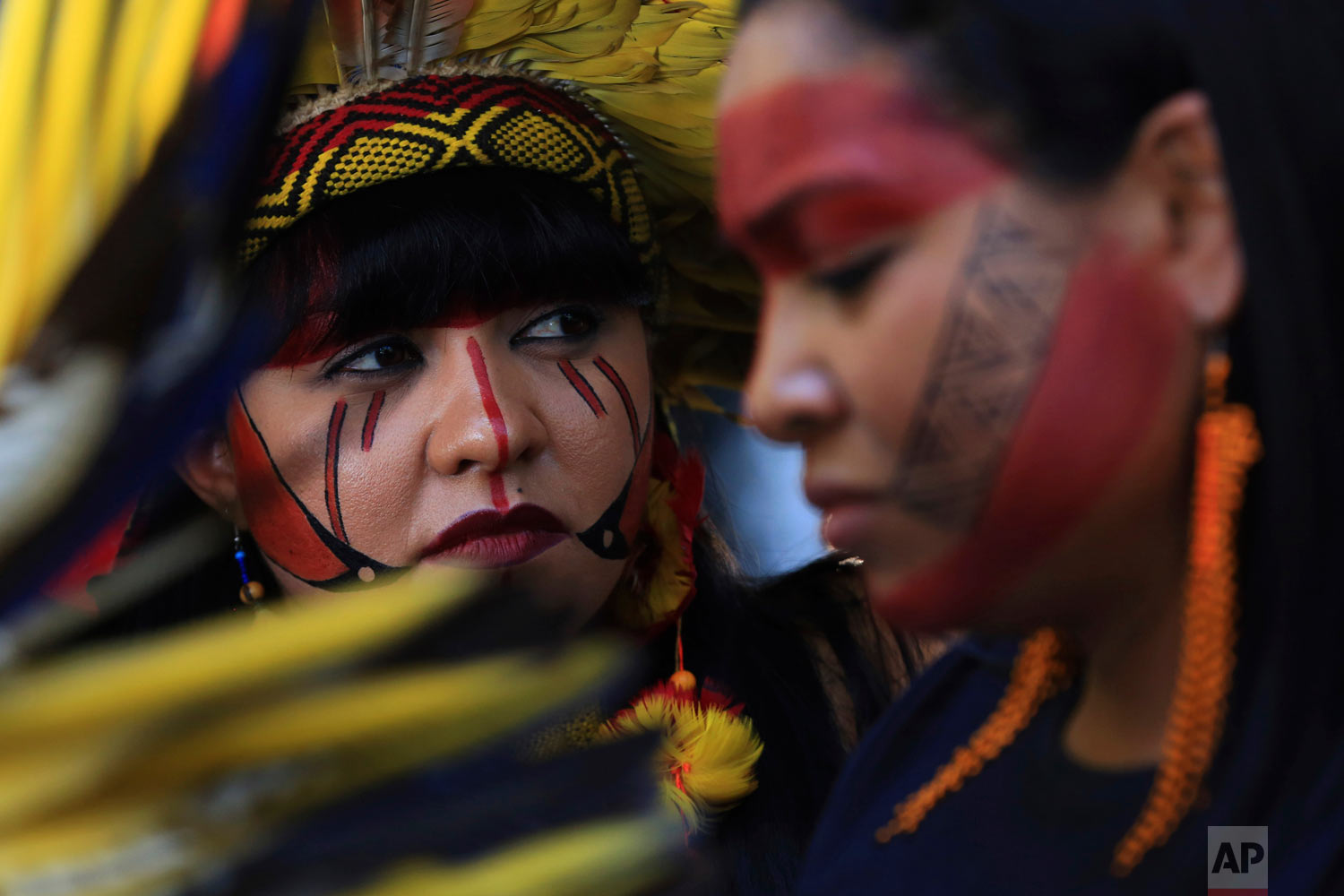 Indigenous women protest the government's policies on land and environmental protections outside the Agriculture Ministry in Brasilia, Brasil, Jan. 31, 2019. (AP Photo/Eraldo Peres)