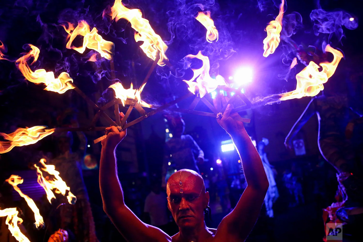 Dancers perform with fire during the Dance, Theater and Visual Arts International Festival Santiago "A Mil" in Santiago, Chile, Jan. 3, 2019. (AP Photo/Esteban Felix)