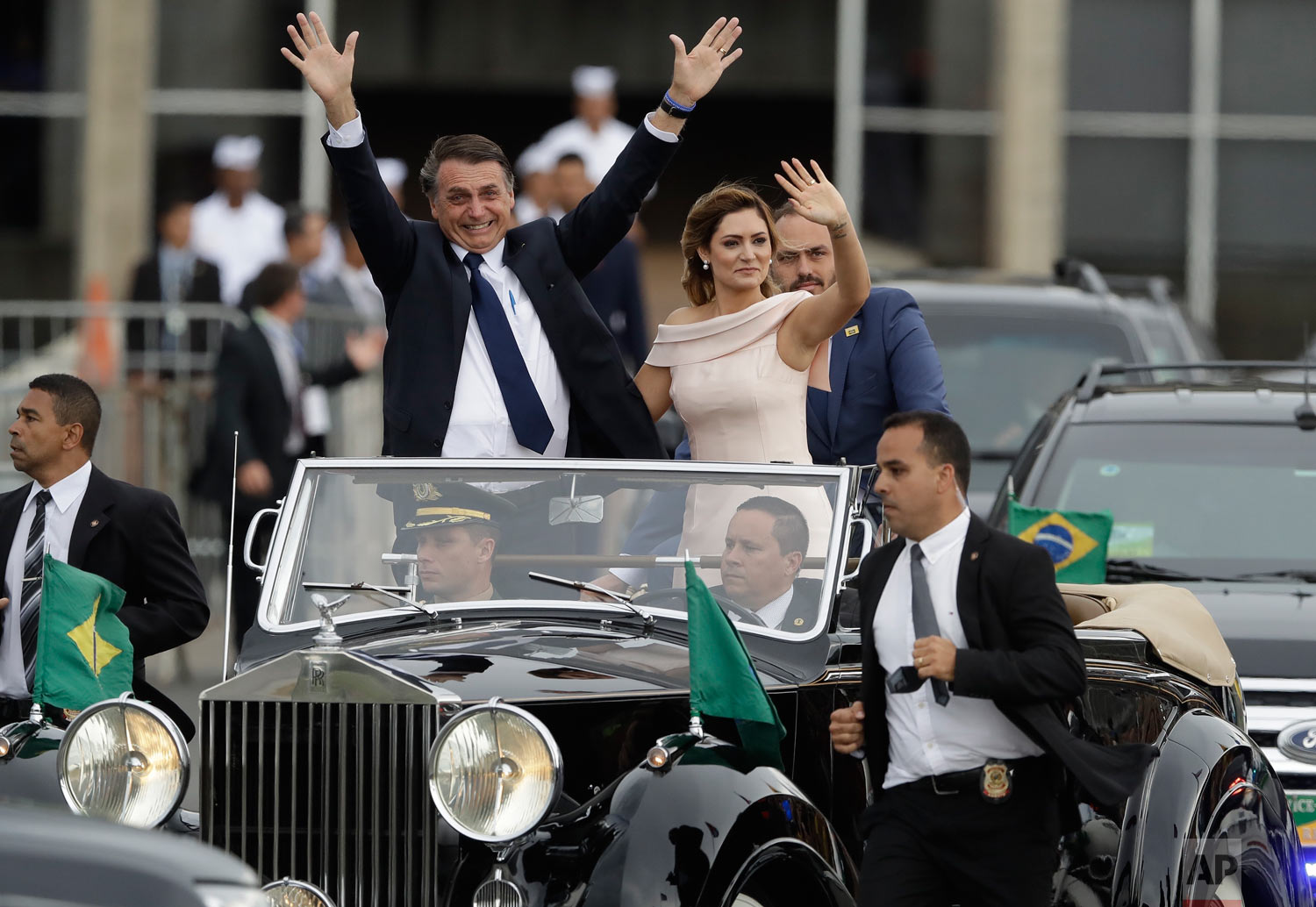  Flanked by first lady Michelle Bolsonaro, Brazil's President Jair Bolsonaro, waves after his swearing-in ceremony in Brasilia, Brazil, Jan. 1, 2019. (AP Photo/Andre Penner) 