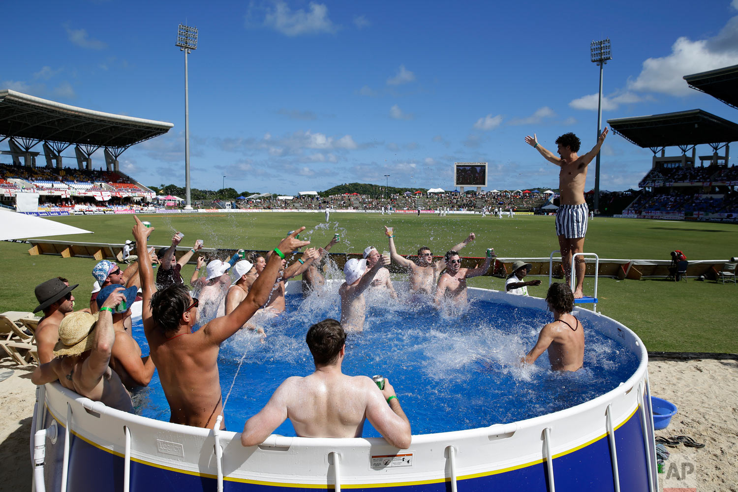  England cricket fans watch the first day of the second Test cricket match against West Indies, from a pool at the Sir Vivian Richards Stadium in North Sound, Antigua and Barbuda, Jan. 31, 2019. (AP Photo/Ricardo Mazalan) 