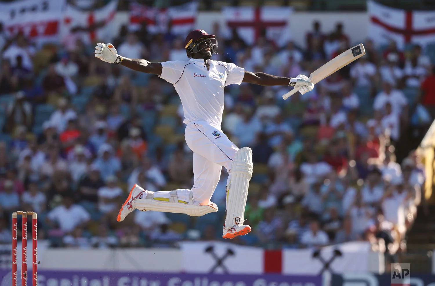 West Indies' captain Jason Holder celebrates his double century against England on the fourth day of their first cricket Test match in Bridgetown, Barbados, Jan. 25, 2019. (AP Photo/Ricardo Mazalan)