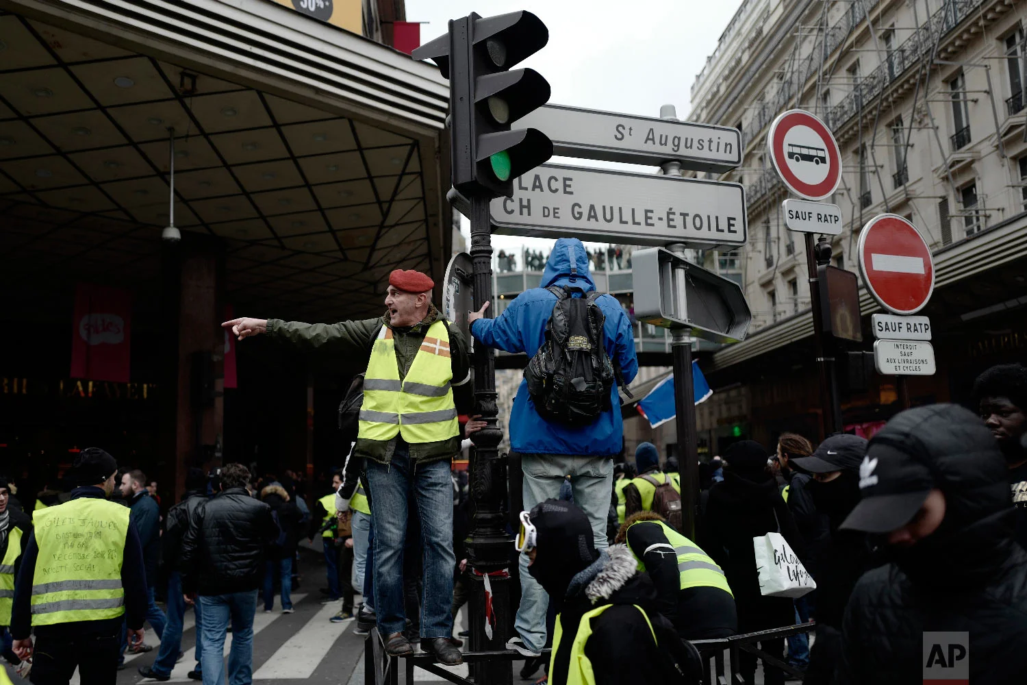 Yellow vest protesters demonstrate peacefully in the streets of Paris, France, Jan. 12, 2019. (AP Photo/Kamil Zihnioglu)