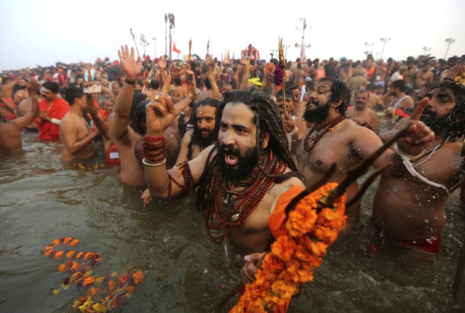 Naga Sadhus, naked Hindu holy men, take dips at Sangam, the confluence of three sacred rivers - the Yamuna, the Ganges and the mythical Saraswati - on Mauni Amavsya or the new moon day, the most auspicious day during the Kumbh Mela in Prayagraj, Uttar Pradesh state, India, on Monday, Feb. 4, 2019. The Kumbh Mela, or the Pitcher Festival, is a series of ritual baths by sadhus and other pilgrims that dates back to at least medieval times. Worshippers bathe in the river believing it cleanses them of their sins and ends their process of reincarnation. The event, which UNESCO added to its list of intangible human heritage in 2017, is the largest congregation of pilgrims on earth. Some 150 million people are expected to attend this year's Kumbh, which runs through early March. (AP Photo/Channi Anand)