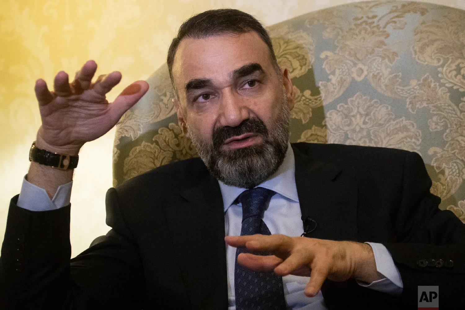 Ata Mohammad Noor, a former warlord who fought Soviet troops and served as governor of the northern Balkh province from 2004-2018, speaks during an interview with The Associated Press in Moscow, Russia on Feb. 8, 2019. (AP Photo/Pavel Golovkin)