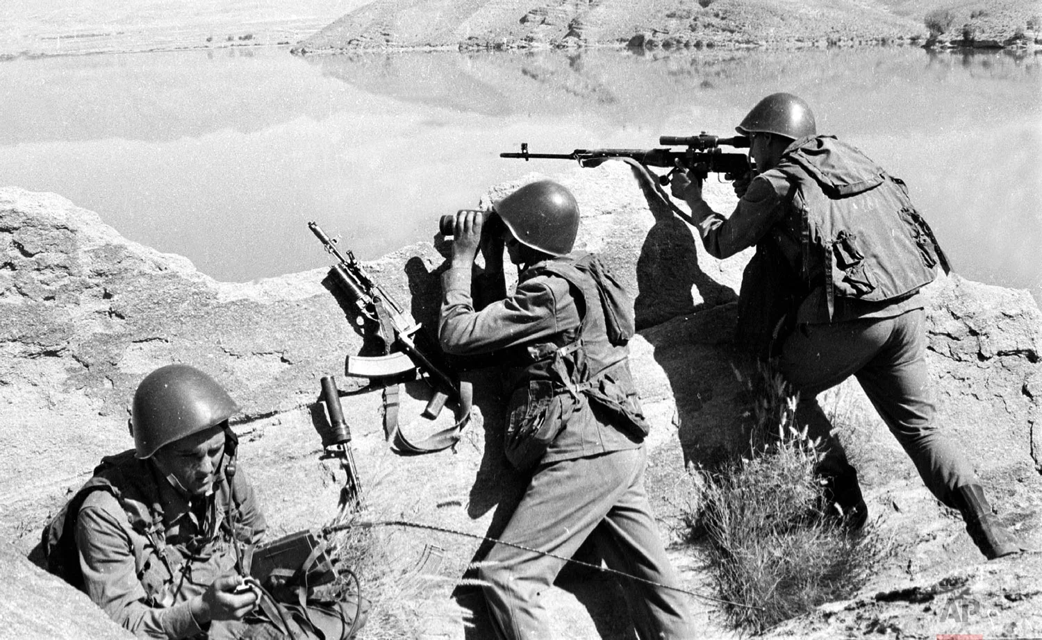 Soviet soldiers observe the highlands, while fighting Islamic guerrillas at an undisclosed location in Afghanistan on April 1988. (AP Photo/Alexander Sekretarev)
