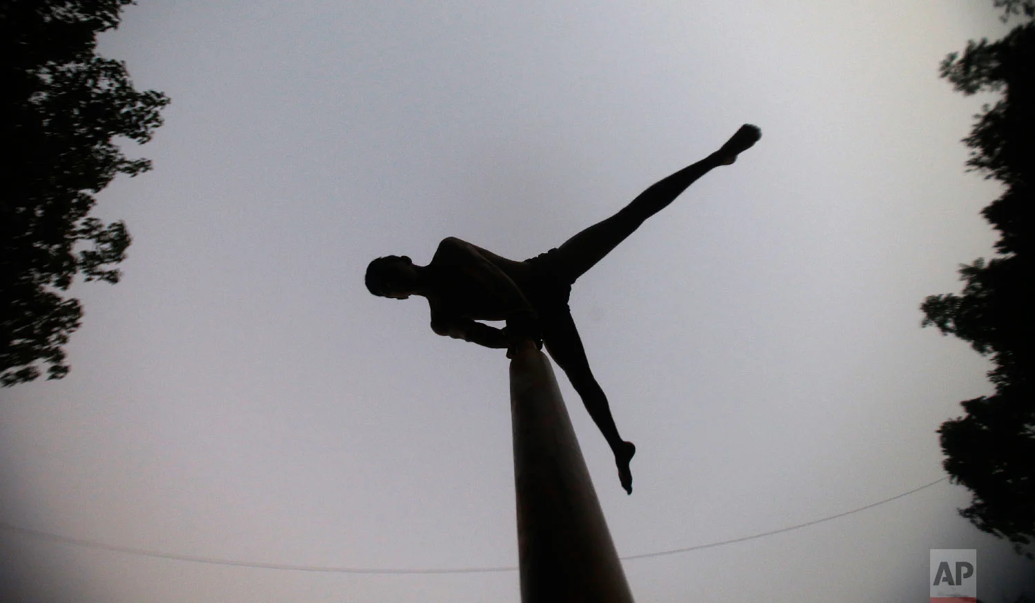 A player performs on a mallakhamb pole at the Shree Samartha Vyayam Mandir on Feb. 5, 2019, in Mumbai, India. (AP Photo/Rafiq Maqbool)