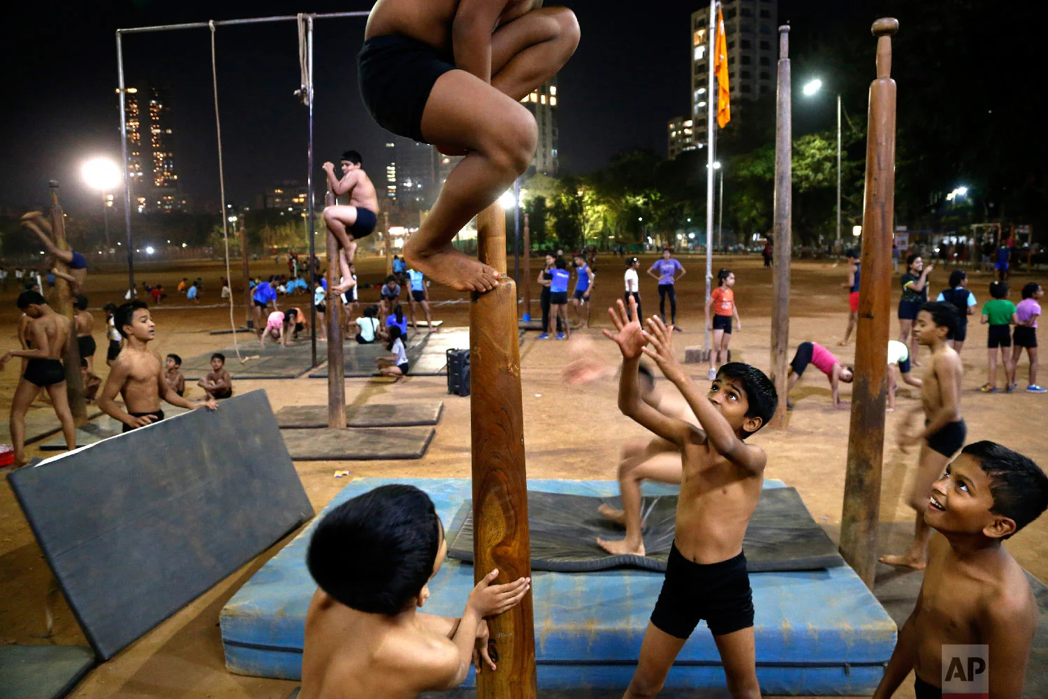 A young player climbs a mallakhamb pole during an early morning class at the Shree Samartha Vyayam Mandir on Feb 6, 2019, at Shivaji Park in Mumbai, India. (AP Photo/Rafiq Maqbool)