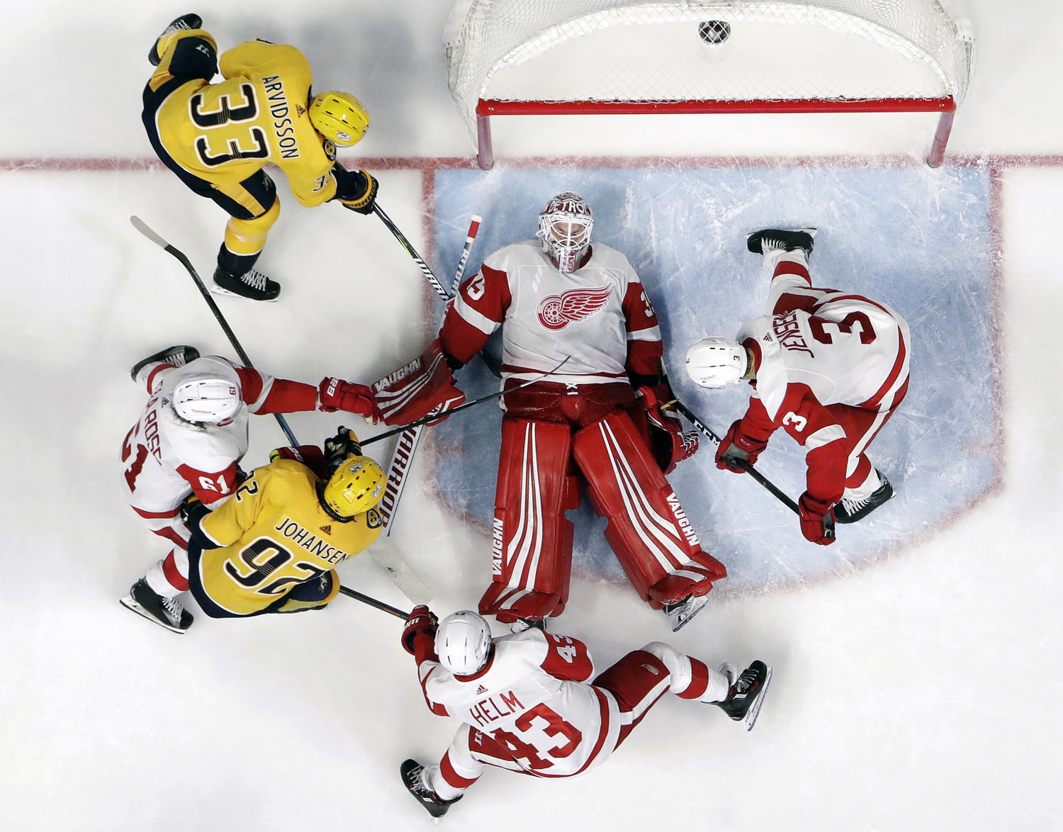 Detroit Red Wings goaltender Jimmy Howard (35) covers the puck during the third period of the team's NHL hockey game against the Nashville Predators on Tuesday, Feb. 12, 2019, in Nashville, Tenn. The Red Wings won 3-2. (AP Photo/Mark Humphrey)