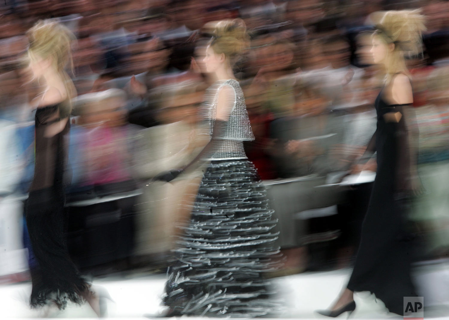 Models present creations for Chanel's fall-winter 2005-2006 haute-couture collection designed by German fashion designer Karl Lagerfeld and presented in Paris, July 7, 2005. (AP Photo/Jerome Delay)