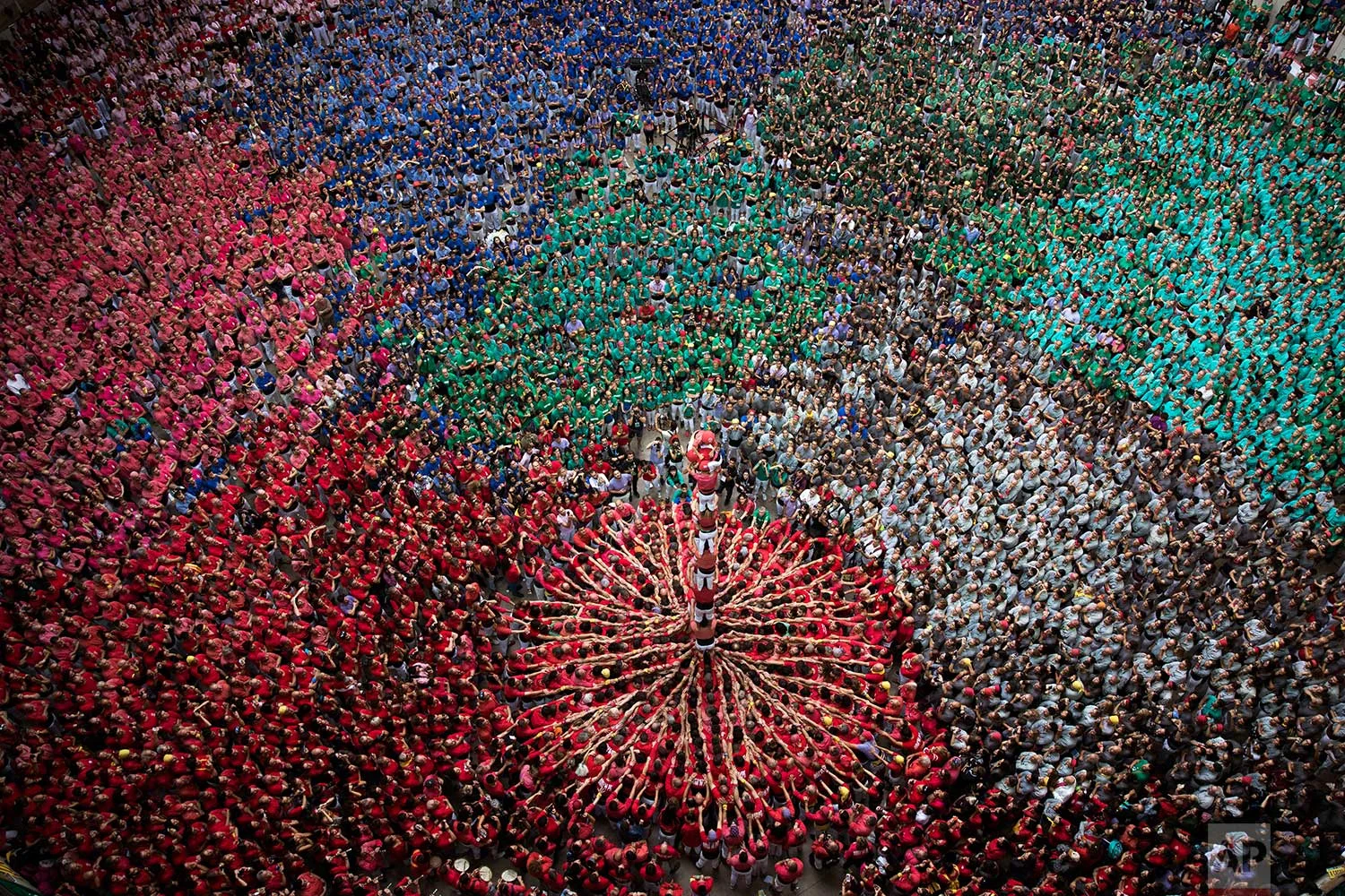 Members of the "Colla Joves Xiquets de Valls" complete their human tower during the 27th Human Tower Competition in Tarragona, Spain, on Sunday, Oct. 7, 2018. The tradition of building human towers or "castells" dates back to the 18th century and takes place during festivals in Catalonia, where "colles" or teams compete to build the tallest and most complicated towers. "Castells" were declared by UNESCO one of the Masterpieces of the Oral and Intangible Heritage of Humanity. (AP Photo/Emilio Morenatti)