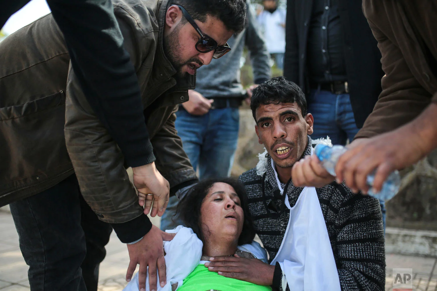 An injured protesting teacher is tended to by colleagues in Rabat, Morocco, Feb. 20, 2019. (AP Photo/Mosa'ab Elshamy)