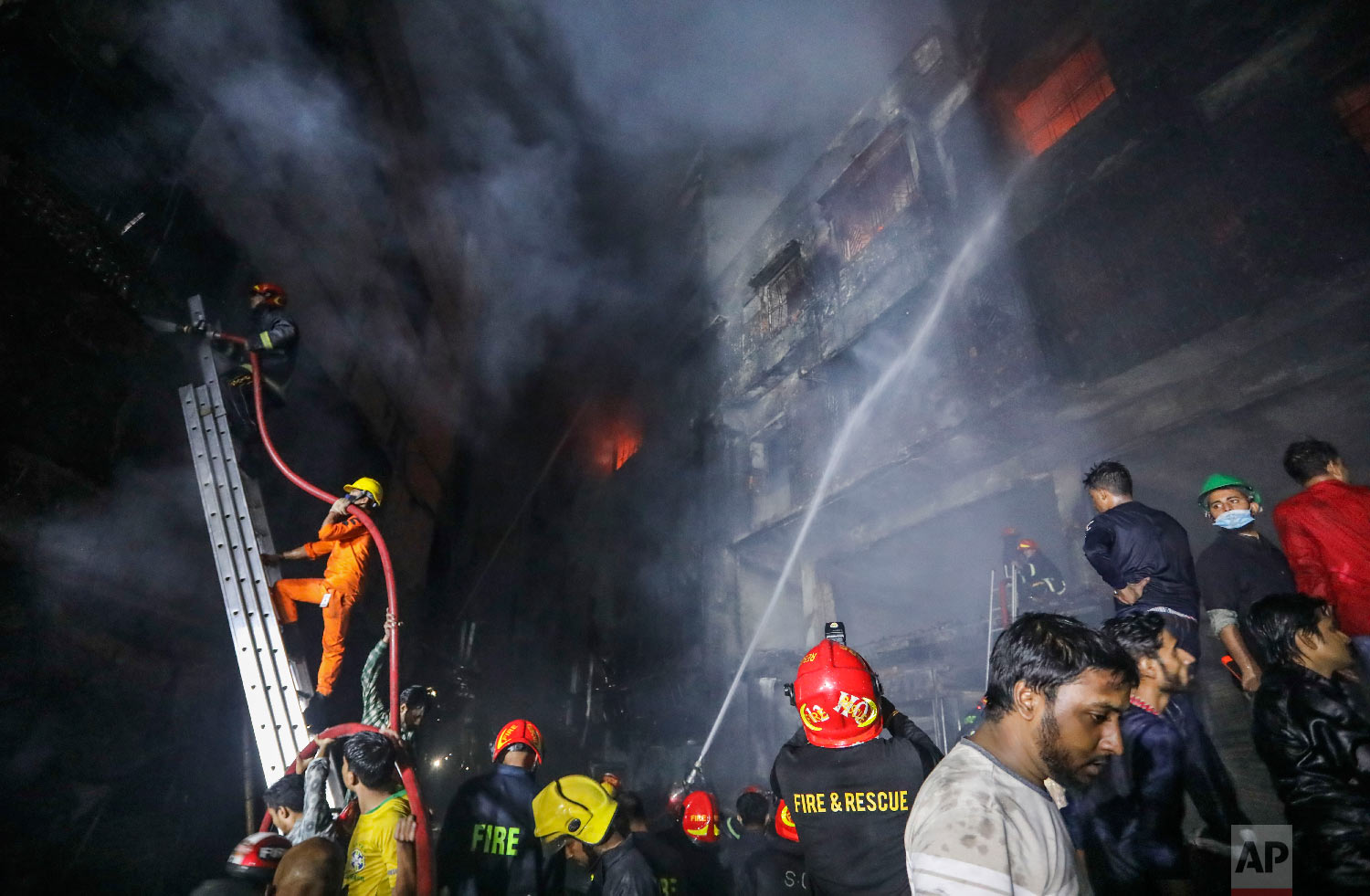 Firefighters work to douse flames in Dhaka, Bangladesh, Thursday, Feb. 21, 2019. (AP Photo/Zabed Hasnain Chowdhury)