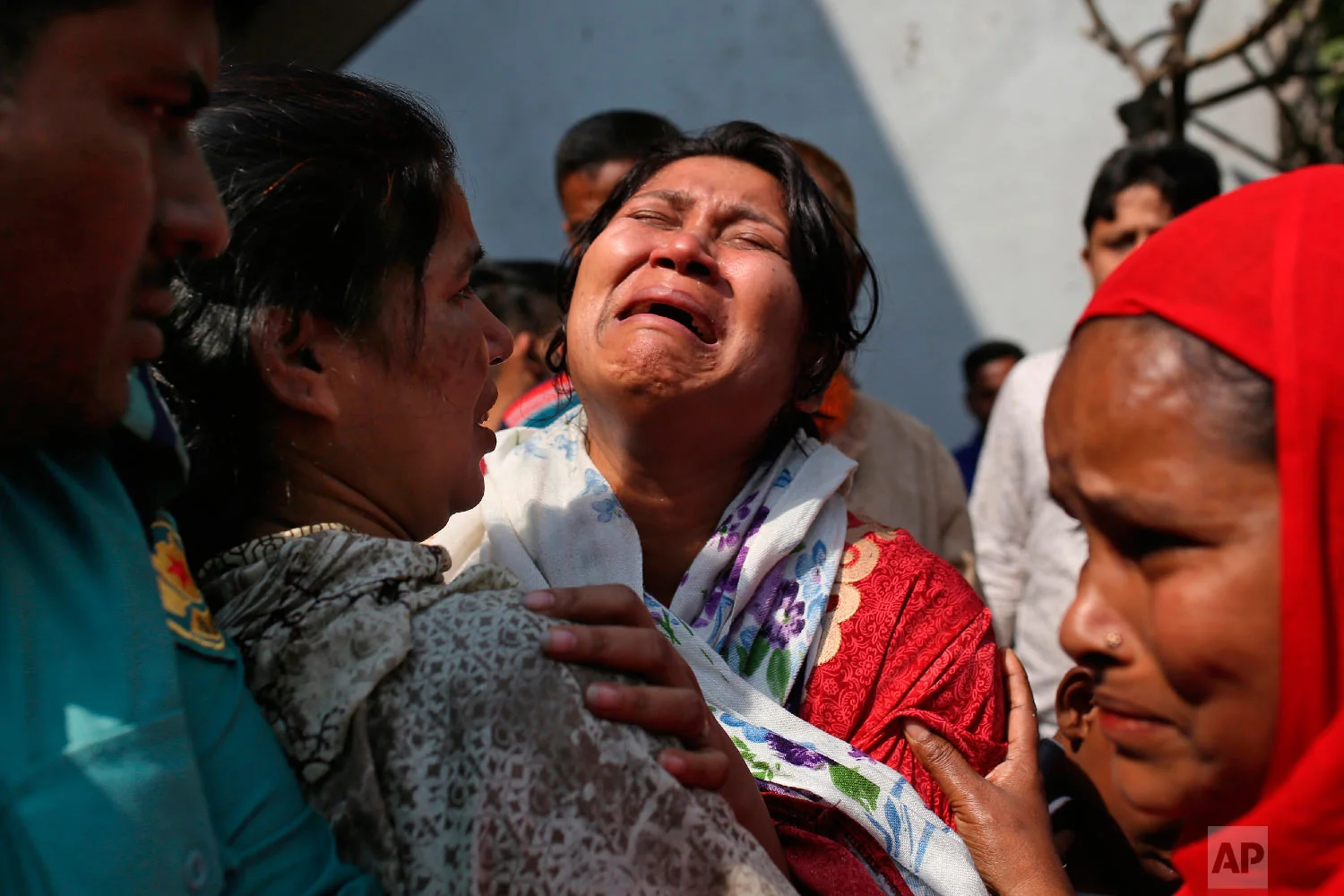 A Bangladeshi woman mourns the death of a relative in a fire, outside a morgue in Dhaka, Bangladesh, Thursday, Feb. 21, 2019. (AP Photo/Rehman Asad)
