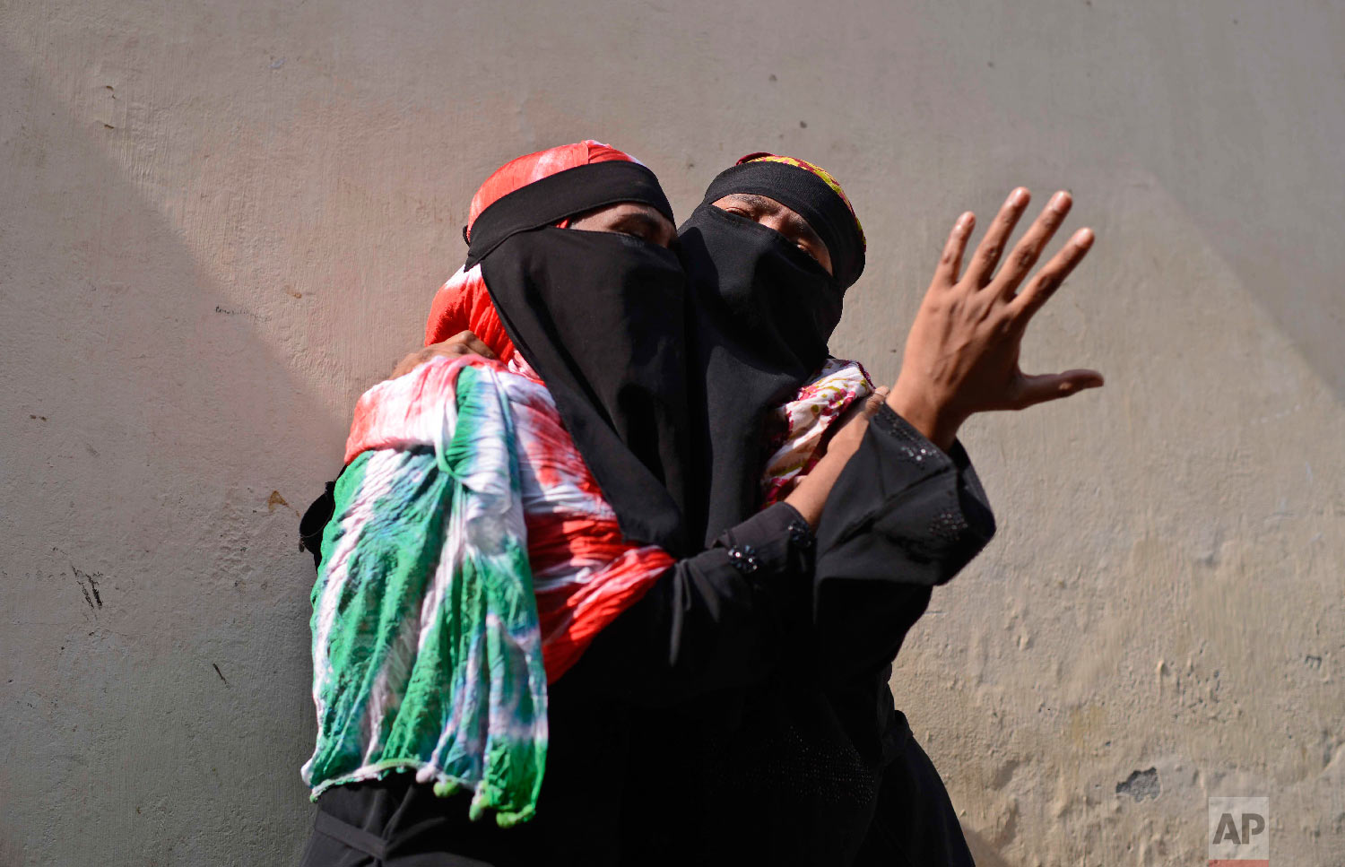 Bangladeshi women mourn as they wait outside a morgue in Dhaka, Bangladesh, Thursday, Feb. 21, 2019. (AP Photo/Mahmud Hossain Opu)