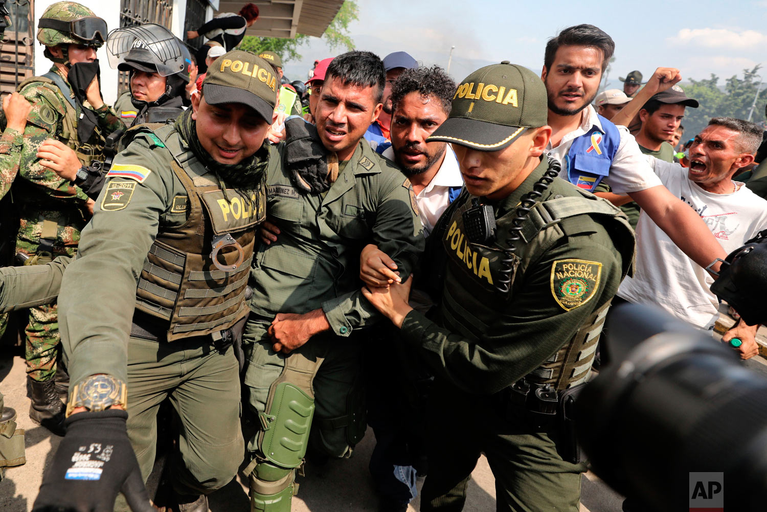  Colombian police escort a Venezuelan soldier who defected at the Simon Bolivar international bridge in Cucuta, Colombia, Saturday, Feb. 23, 2019. (AP Photo/Fernando Vergara) 