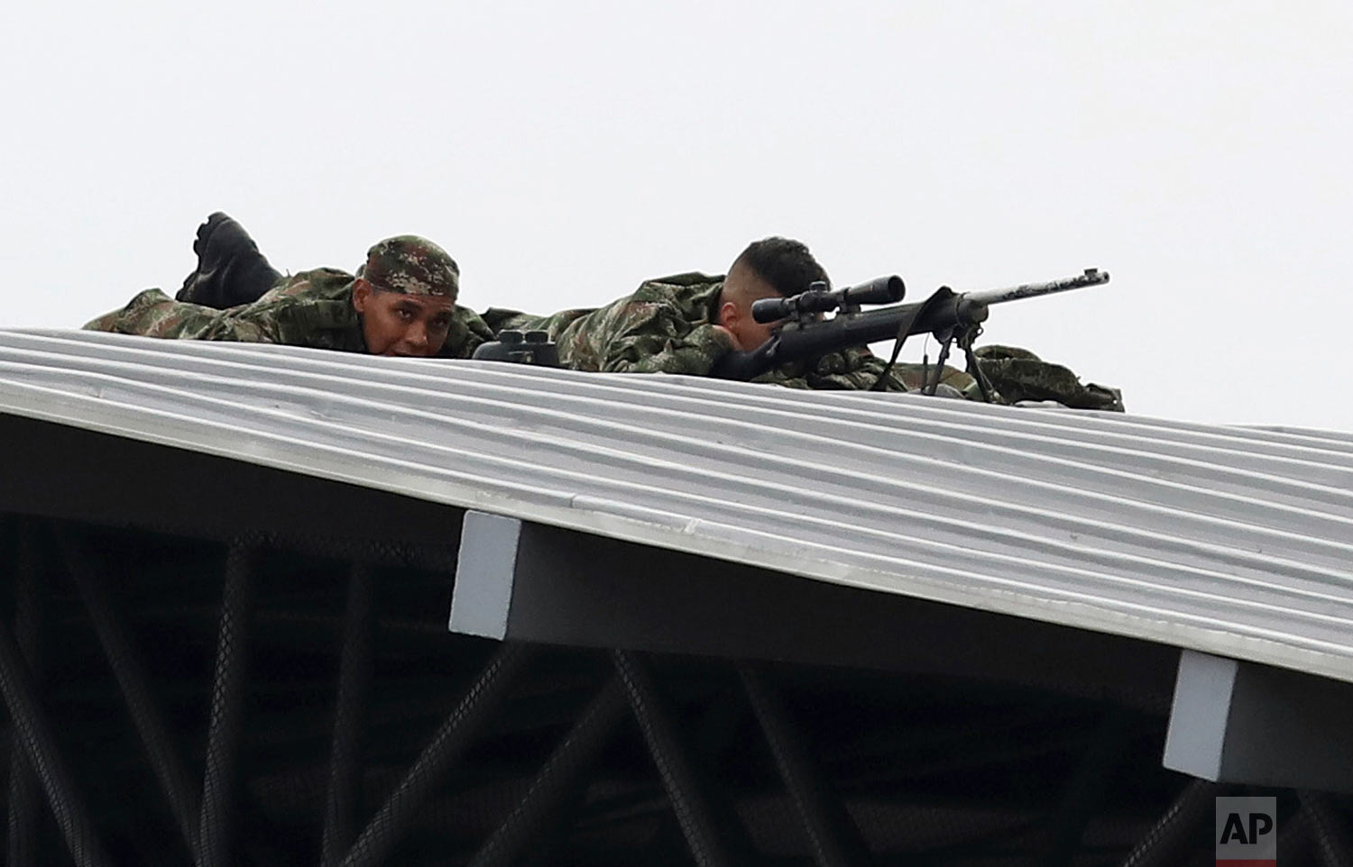 Colombian army snipers cover the Venezuela Aid Live concert on the Colombian side of the Tienditas International Bridge near Cucuta, Colombia, on the border with Venezuela, Friday, Feb. 22, 2019. (AP Photo/Fernando Vergara)