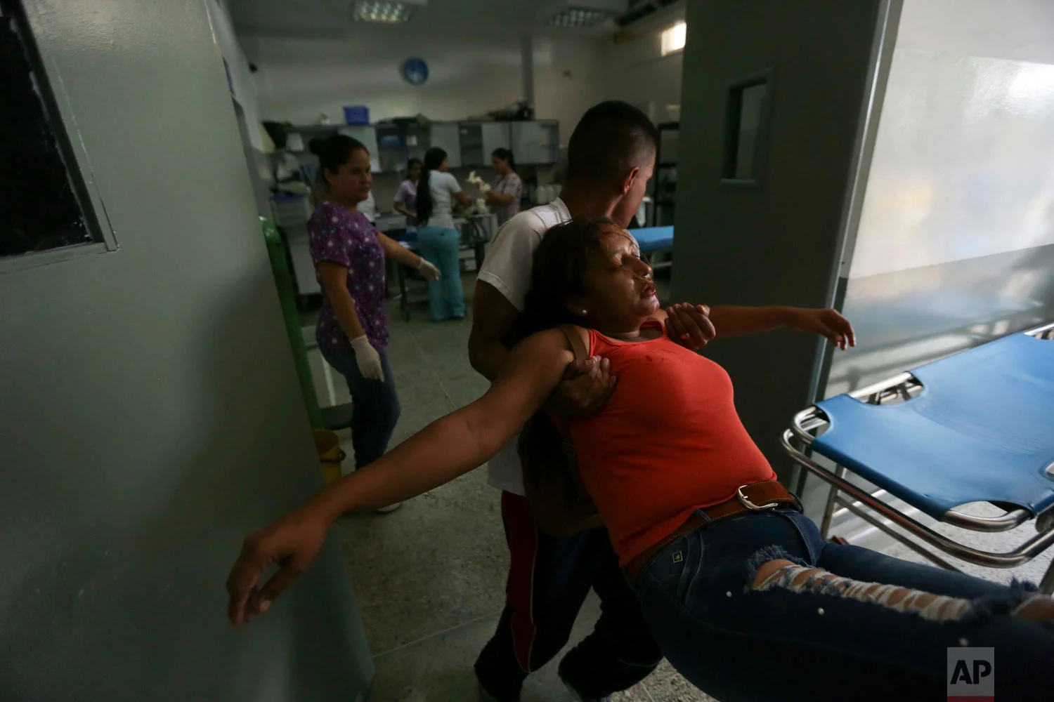Joyce Brito is tended to by emergency room personnel after she was wounded in the chin during clashes with the Venezuelan Bolivarian National Guard in Urena, Venezuela, near the border with Colombia, Saturday, Feb. 23, 2019. (AP Photo/Fernando Llano)