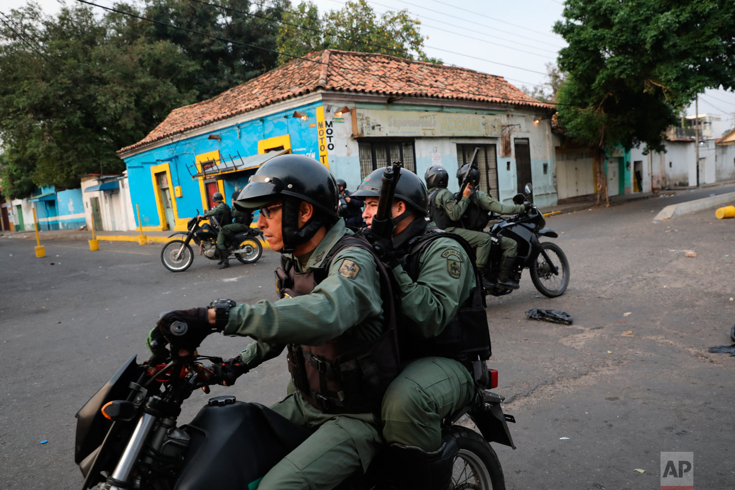  Venezuelan Bolivarian National Guards patrol on motorcycles clashes with protesters in Urena, Venezuela, near the border with Colombia, Saturday, Feb. 23, 2019. (AP Photo/Rodrigo Abd) 