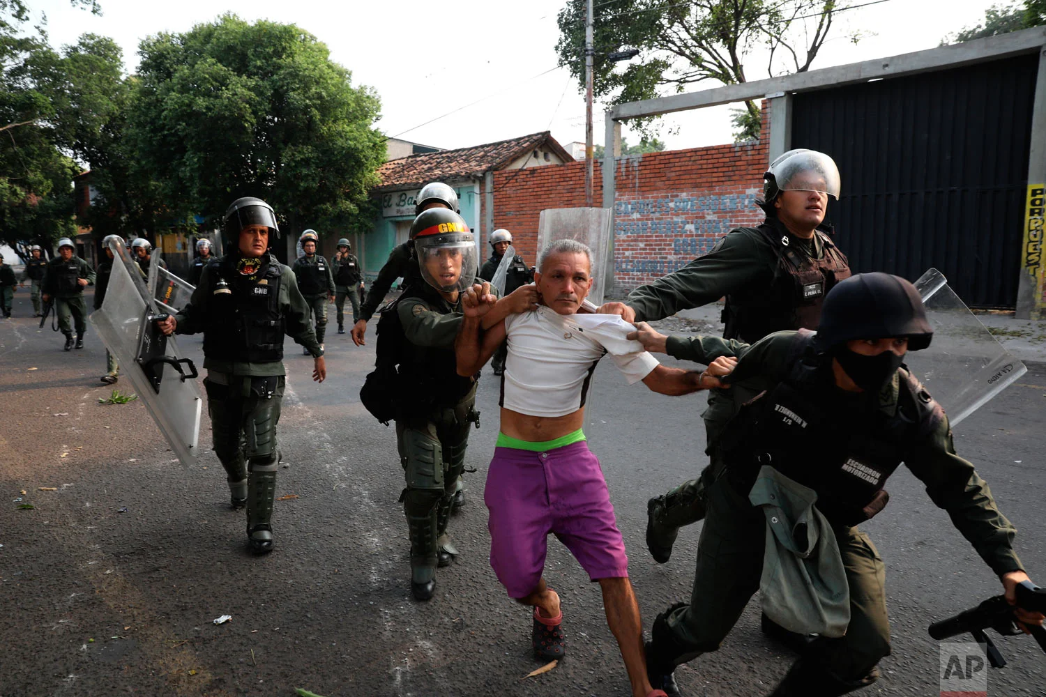 A man is detained during clashes with the Venezuelan Bolivarian National Guard in Urena, Venezuela, near the border with Colombia, Saturday, Feb. 23, 2019. (AP Photo/Rodrigo Abd)