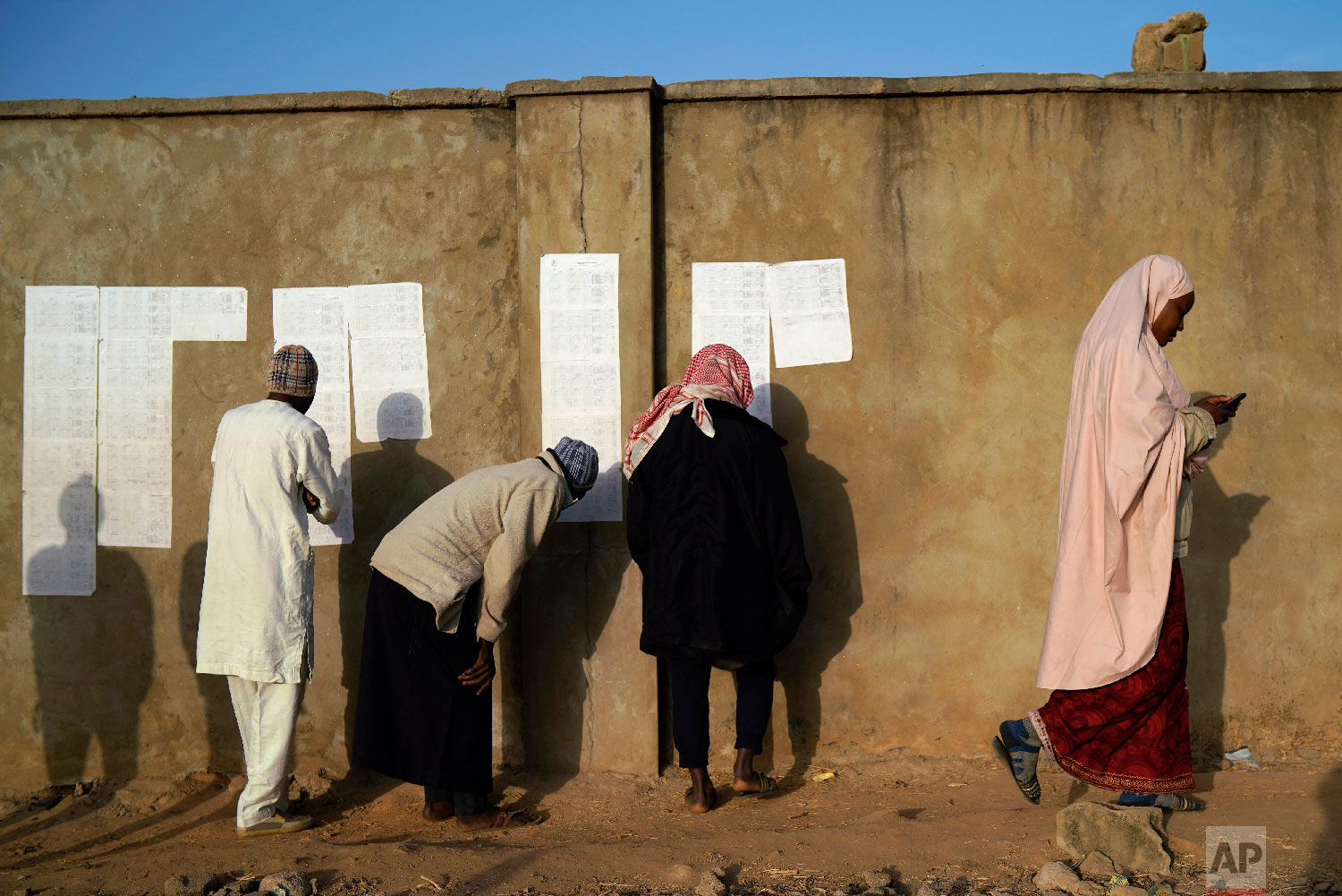Nigerians check voters' lists at a polling station in Kaduna, Nigeria, Feb. 16, 2019. (AP Photo/Jerome Delay)