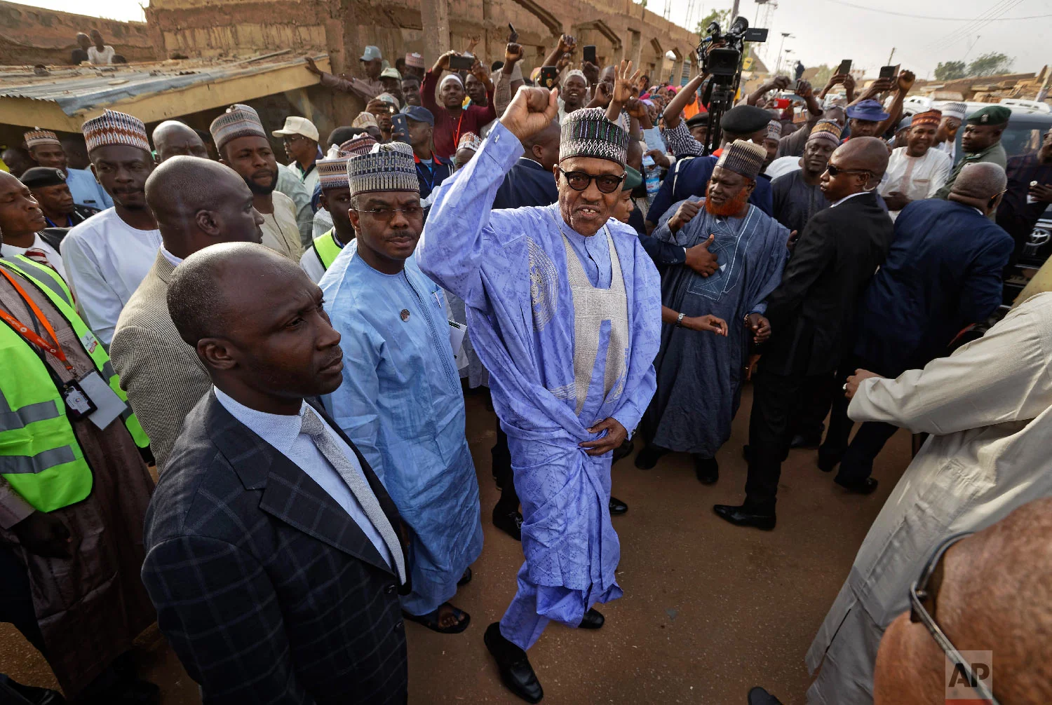 Nigeria's President Muhammadu Buhari gestures to supporters after casting his vote in his hometown of Daura, northern Nigeria, Feb. 23, 2019. (AP Photo/Ben Curtis)