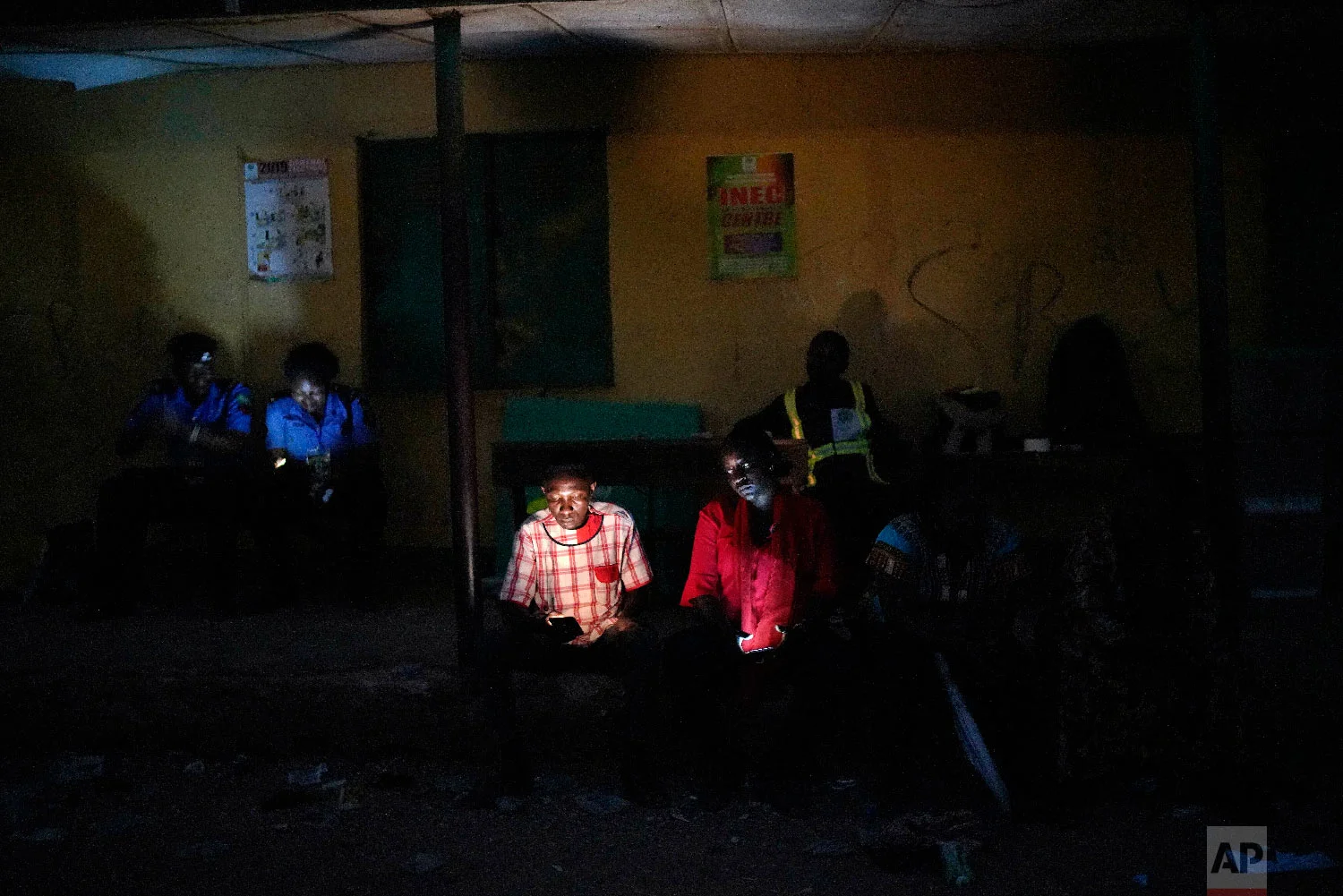 Nigerian election volunteers and police wait for votes to finish being counted in Kaduna, Nigeria, Feb. 23, 2019. (AP Photo/Jerome Delay)