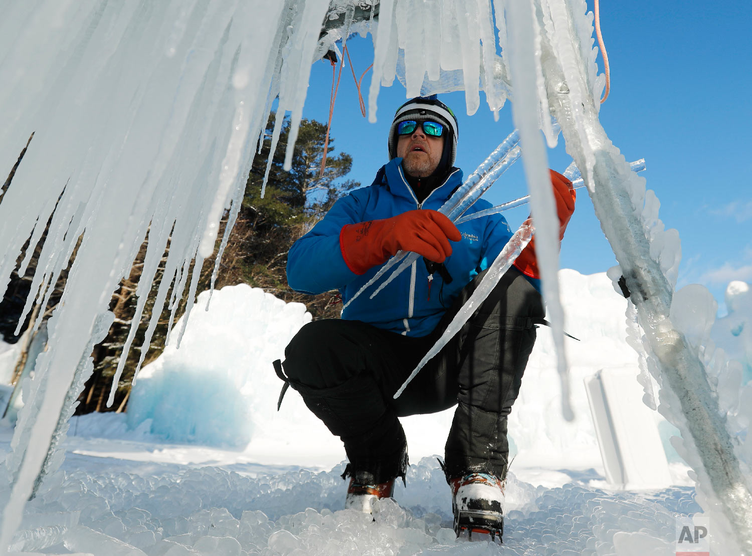 Andrew Reverio harvests icicles in North Woodstock, N.H., on Jan. 2, 2019. (AP Photo/Robert F. Bukaty)