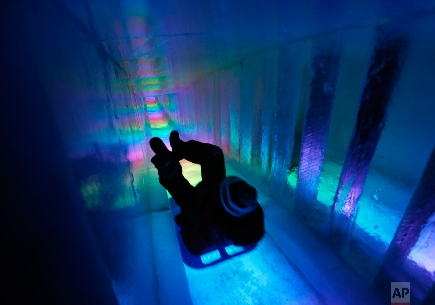 A man zooms down a 97-foot ice slide at Ice Castles in North Woodstock, N.H., on Jan. 26, 2019. (AP Photo/Robert F. Bukaty)